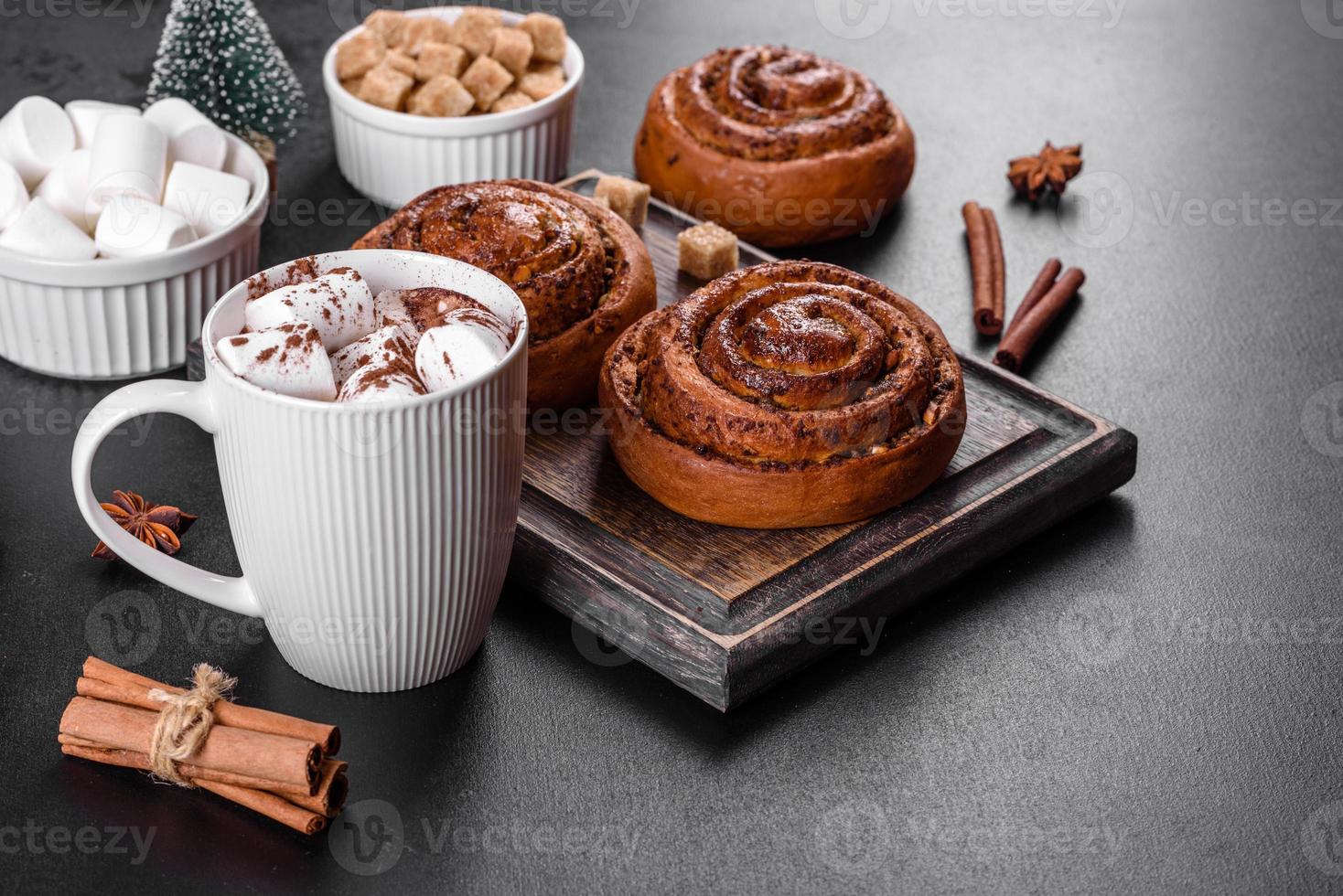 Freshly baked cinnamon roll with spices and cocoa filling on a black background photo