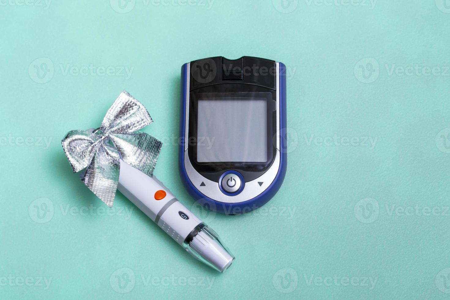 Christmas banner with holiday decorations and a glucometer for measuring blood sugar on a colored background. Christmas card concept for doctors with copy space. Close-up. photo