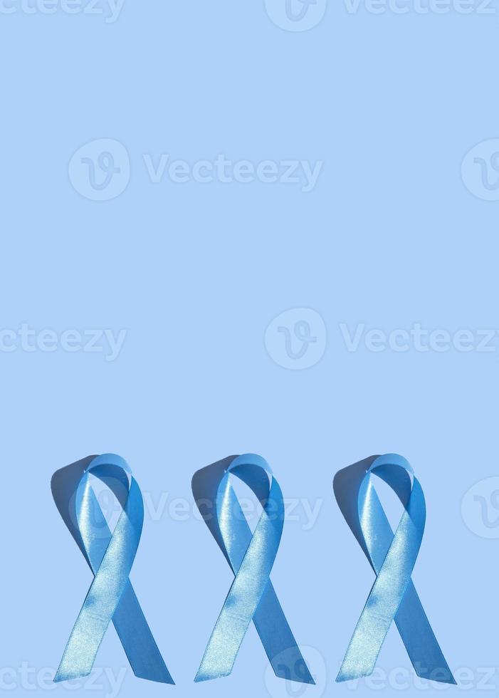 Concept for world diabetes day 14 november. Symbolic color bow to raise awareness on the day of diabetes on a blue background. photo