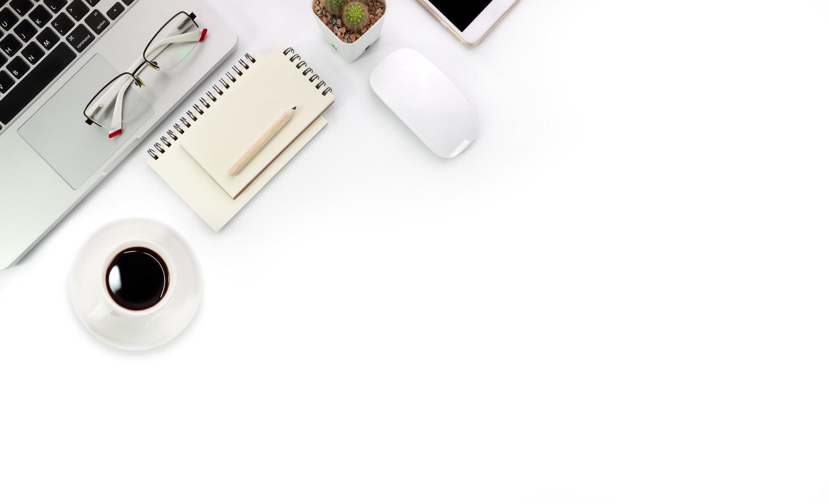 simple workspace technology white table with laptop computer, coffee cup notebook and copy space photo