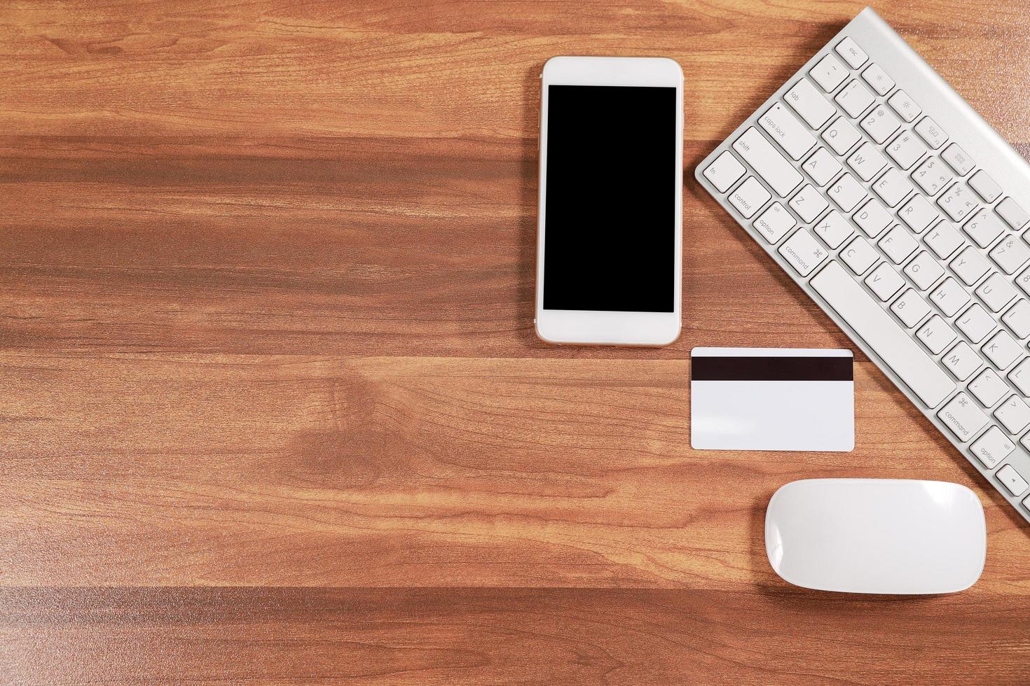 wooden workspace business desk with computer, smartphone and credit card photo