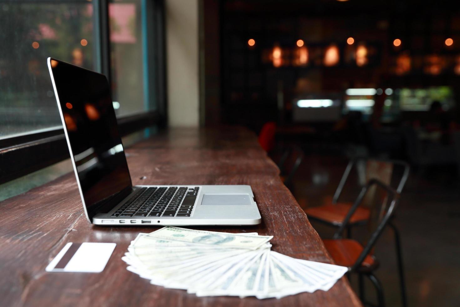 computer with money and credit card on desk photo
