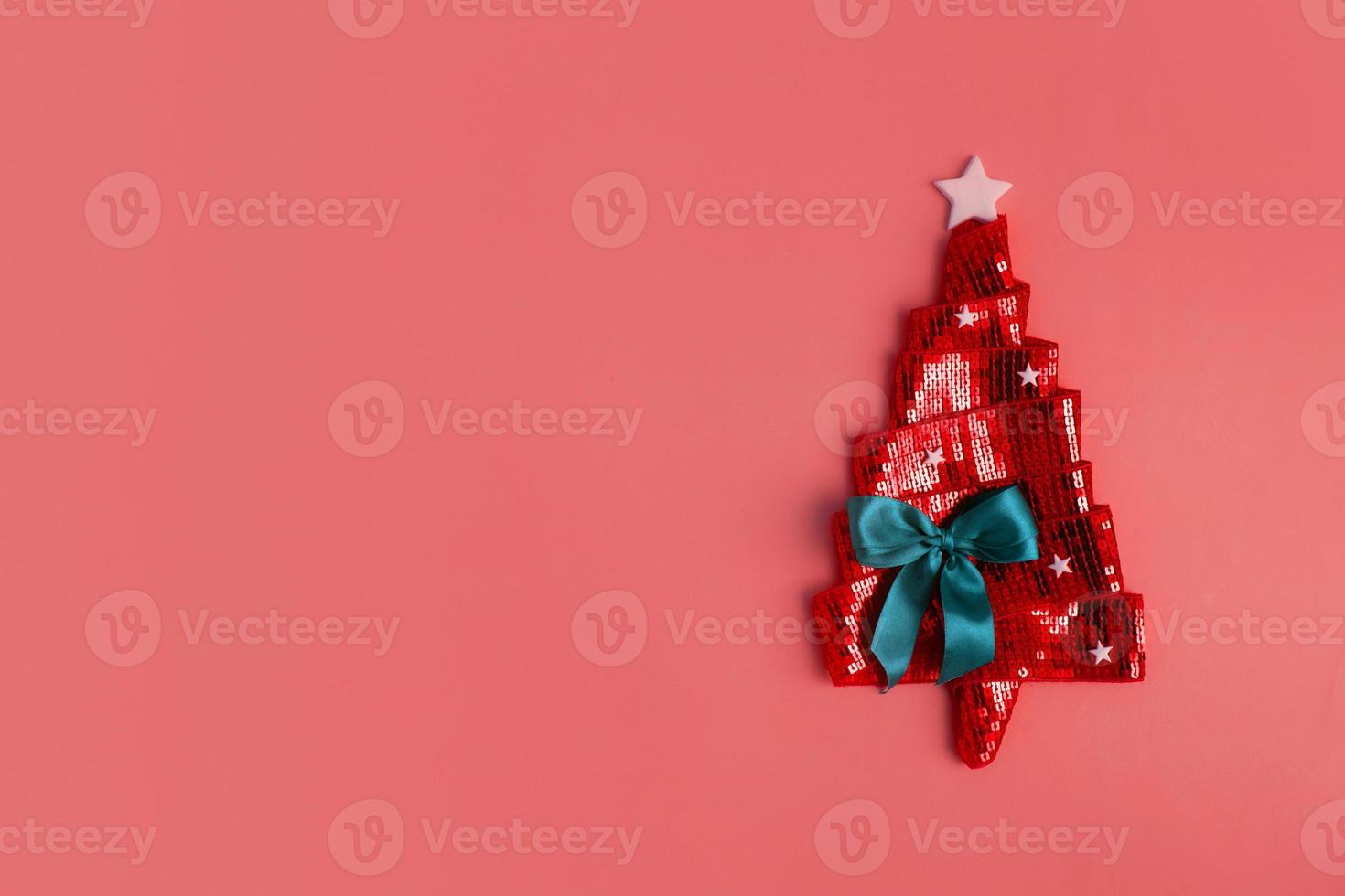 Happy New Year greeting card with flat lay abstract shiny Christmas tree made of ribbon. Copy space photo