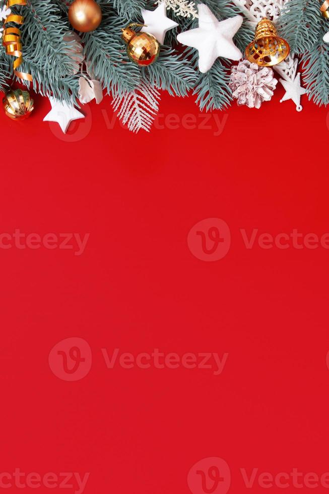 Flat lay christmas decorations on red background with copy space photo