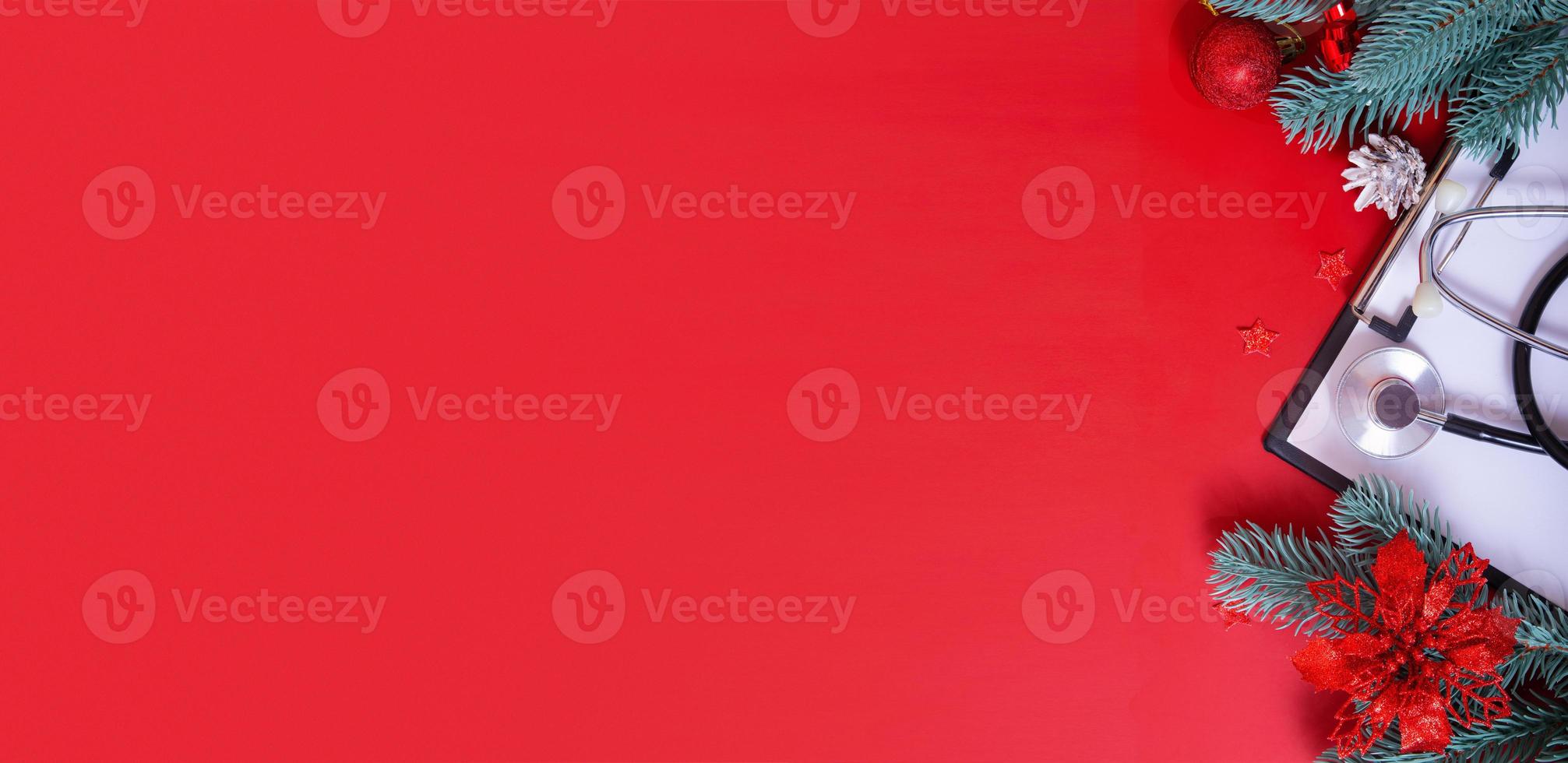 Banner with medical stethoscope and christmas decorations on red background with copy space photo
