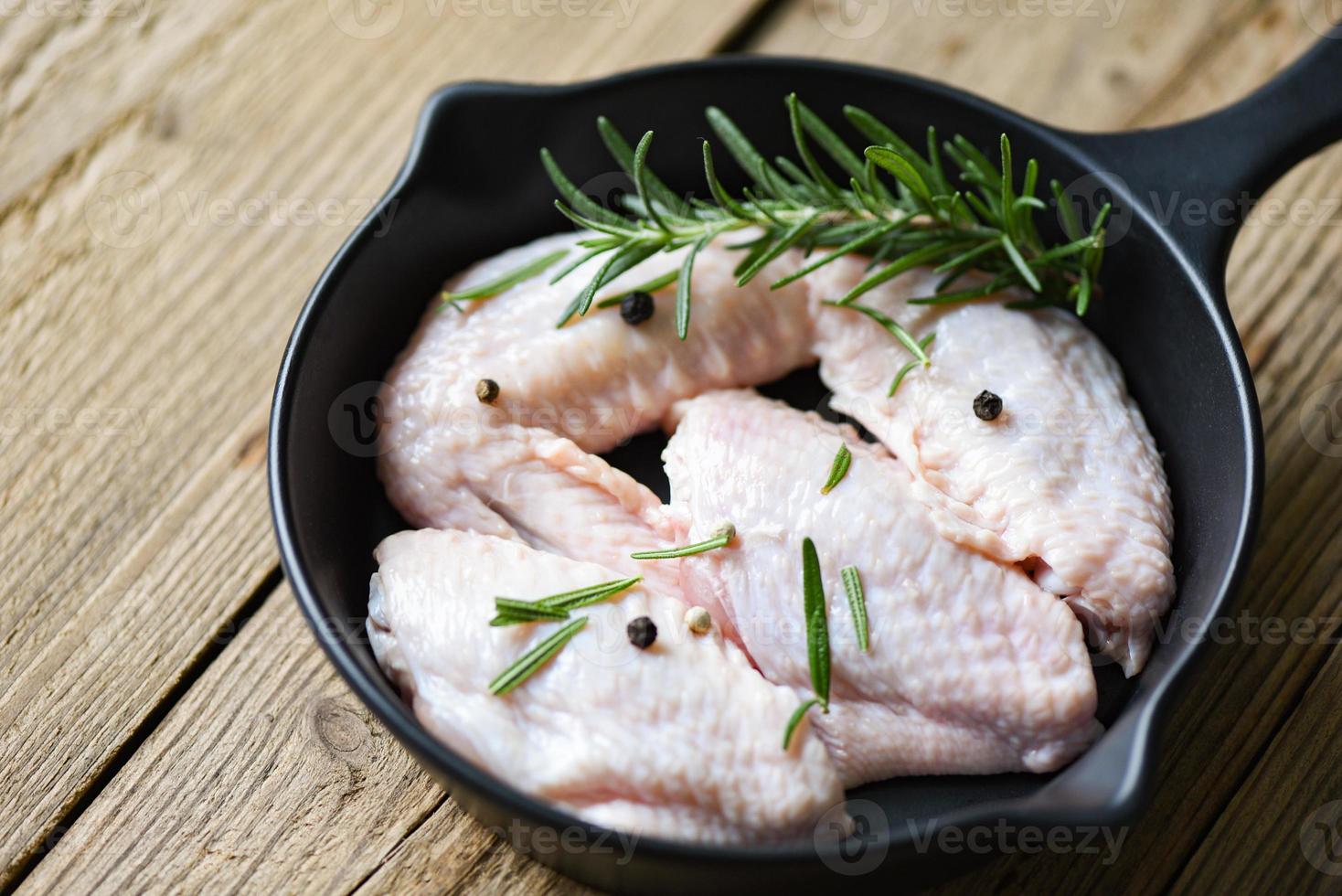 Raw chicken wings, herbs and spices for cooking thai asian food rosemary chicken. photo