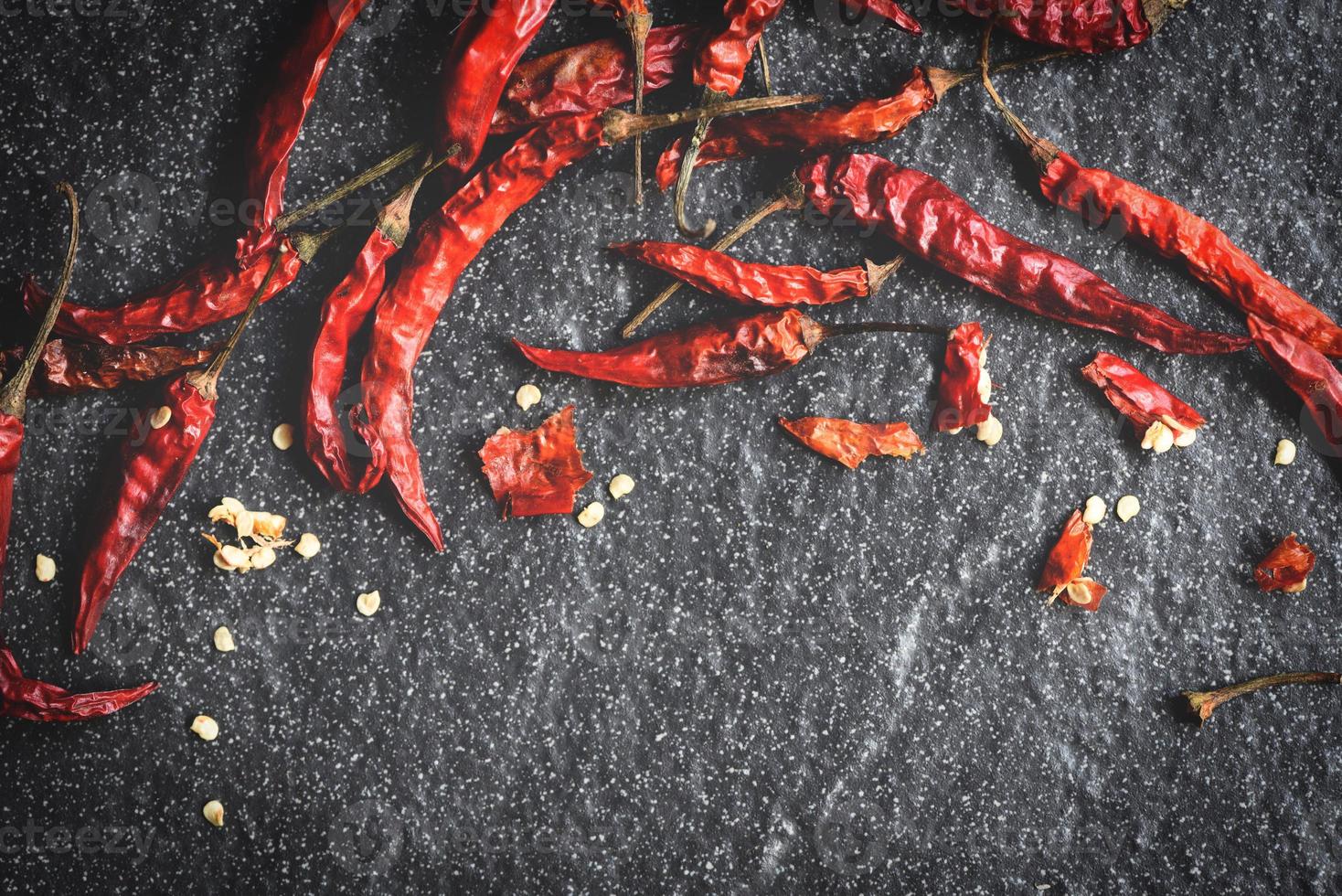 Dried chili on dark background - Red dried chilli pepper cayenne on a stone photo
