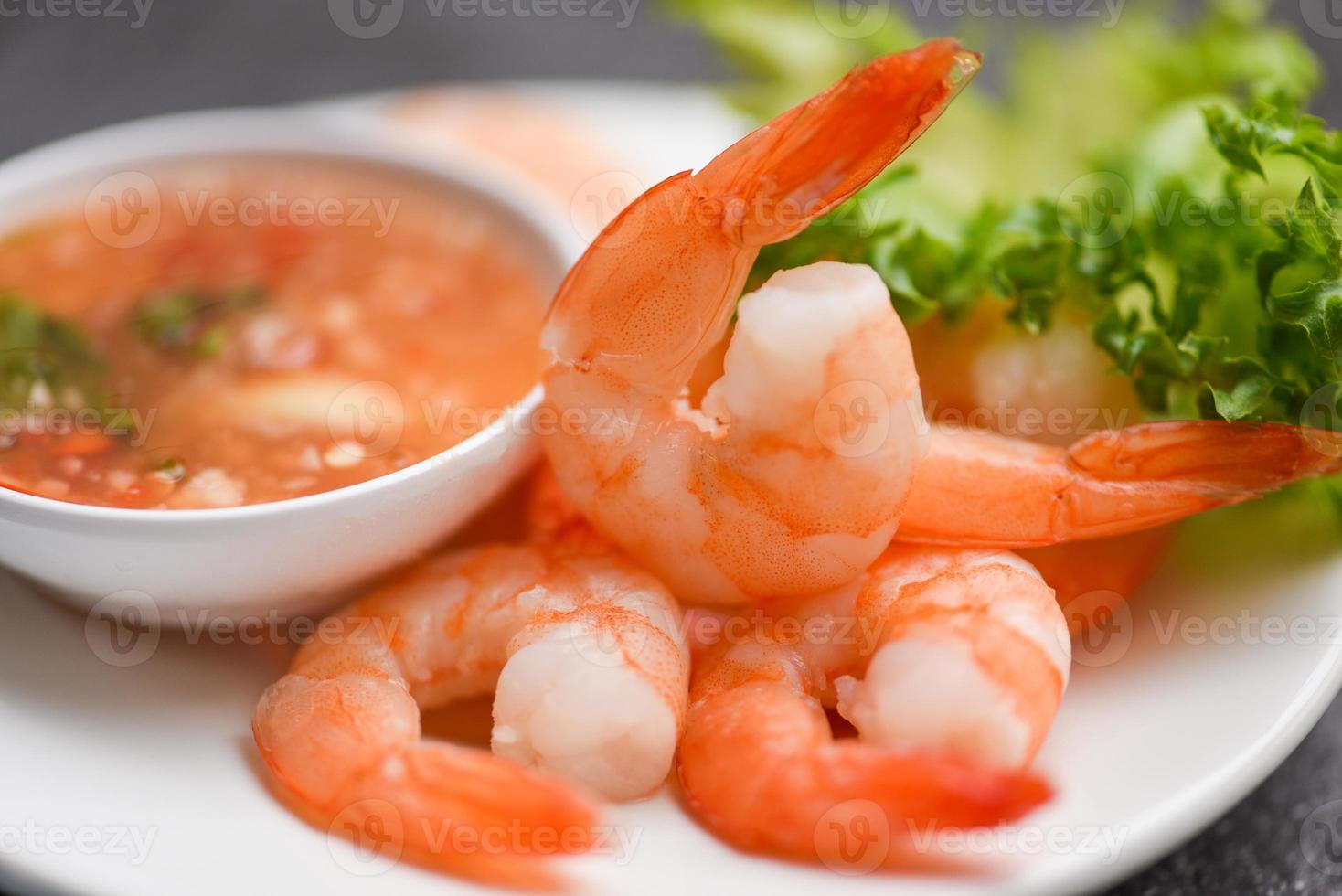 Shrimp delicious seasoning spices on white plate appetizing cooked boiled shrimps prawns , salad shelfish seafood sauce photo