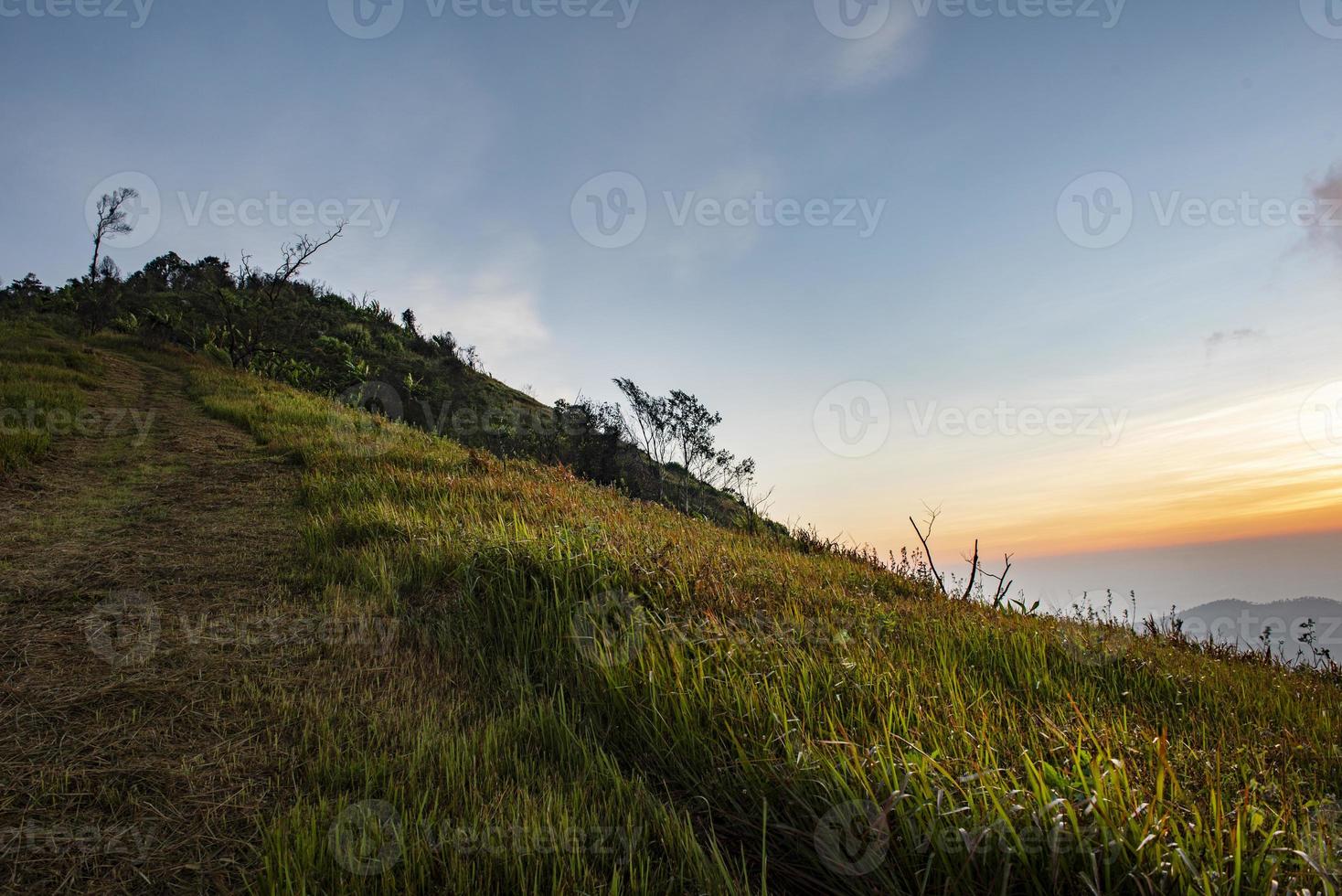 paisaje amanecer en la montaña con campo y prado de hierba hermoso cielo. foto