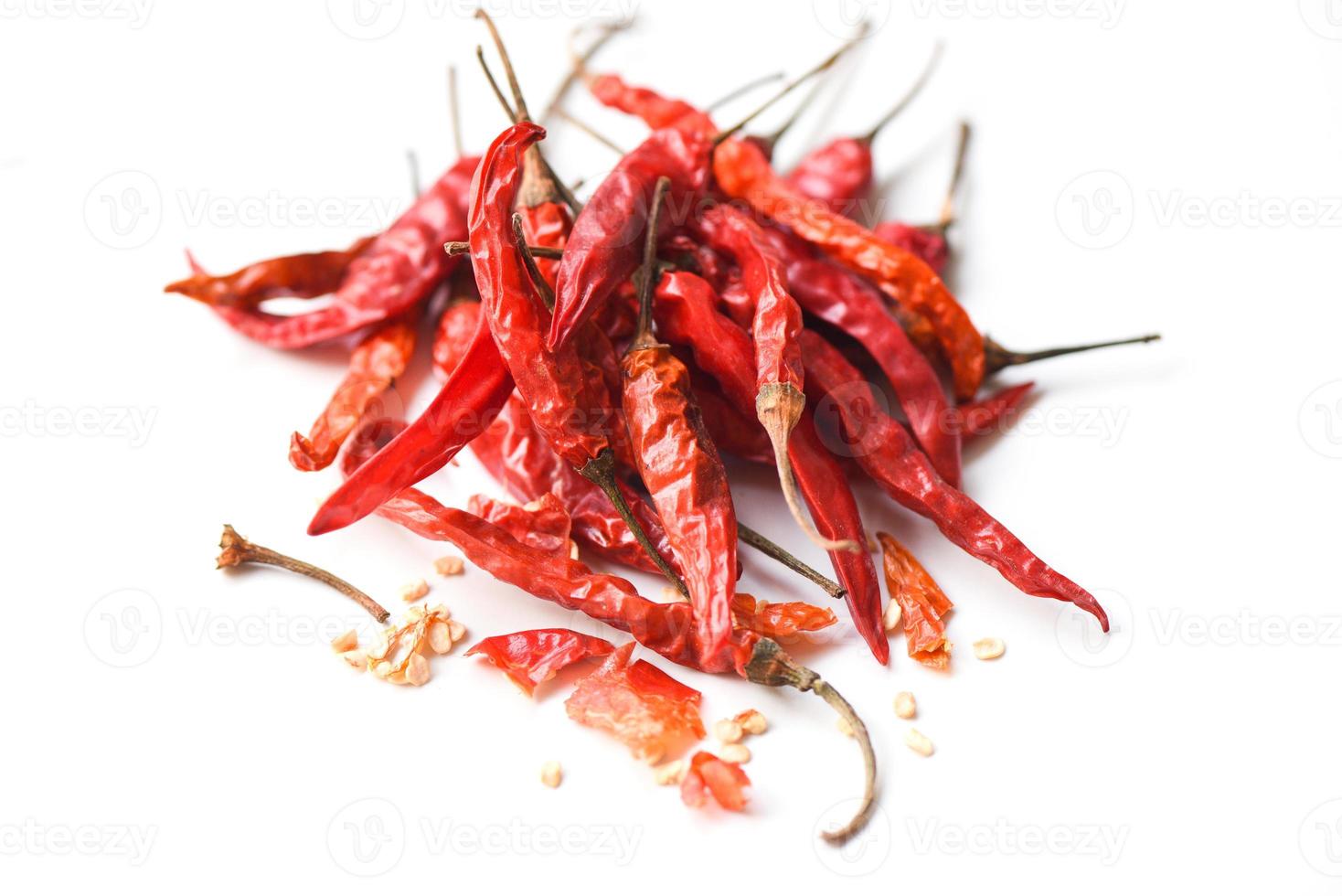 Dried chili on white background - pile of red dried chilli pepper cayenne photo