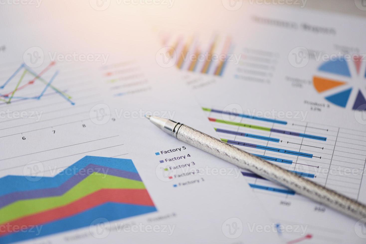 Summary report in Statistics circle Pie chart on paper business document financial chart and graph with pen - Business report chart preparing graphs concept photo