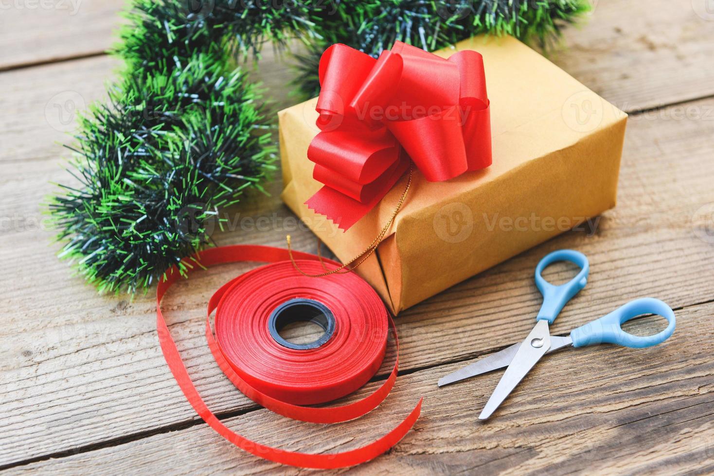 diy gift concept Homemade wrapped christmas presents with tools and decorations on wooden , DIY hobby gift box wrapped brown paper collection in for christmas or new year photo