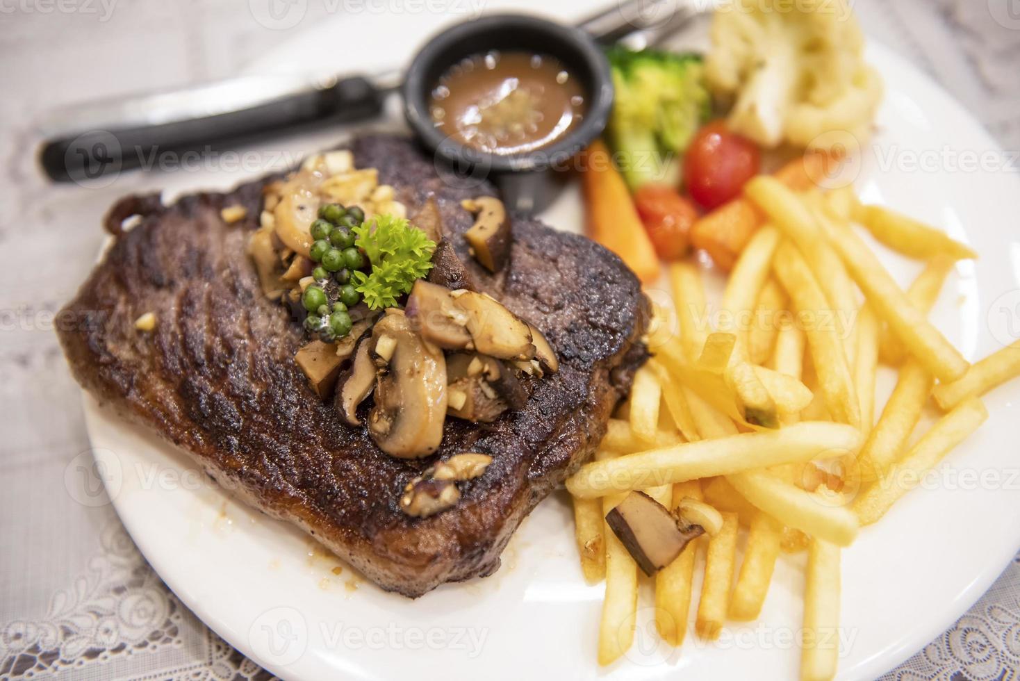 Roasted steak meat with vegetable herb spices black pepper corn and mushroom, grilled steak beef with french fries on plate on the dining table food photo