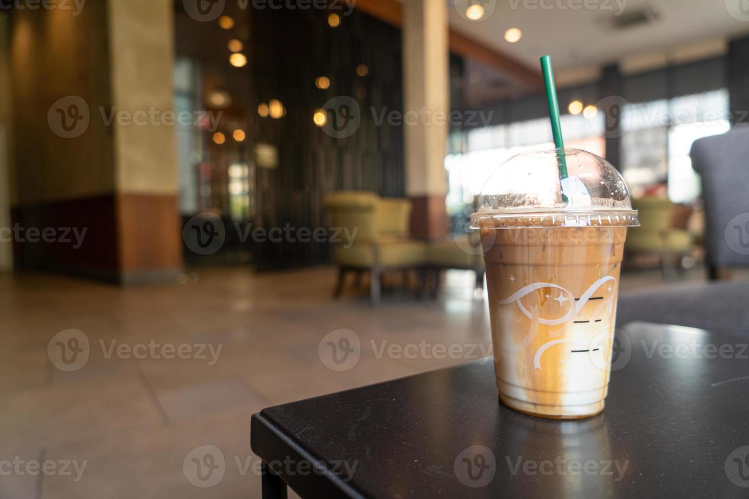 caramel macchiato coffee cup in coffee shop photo