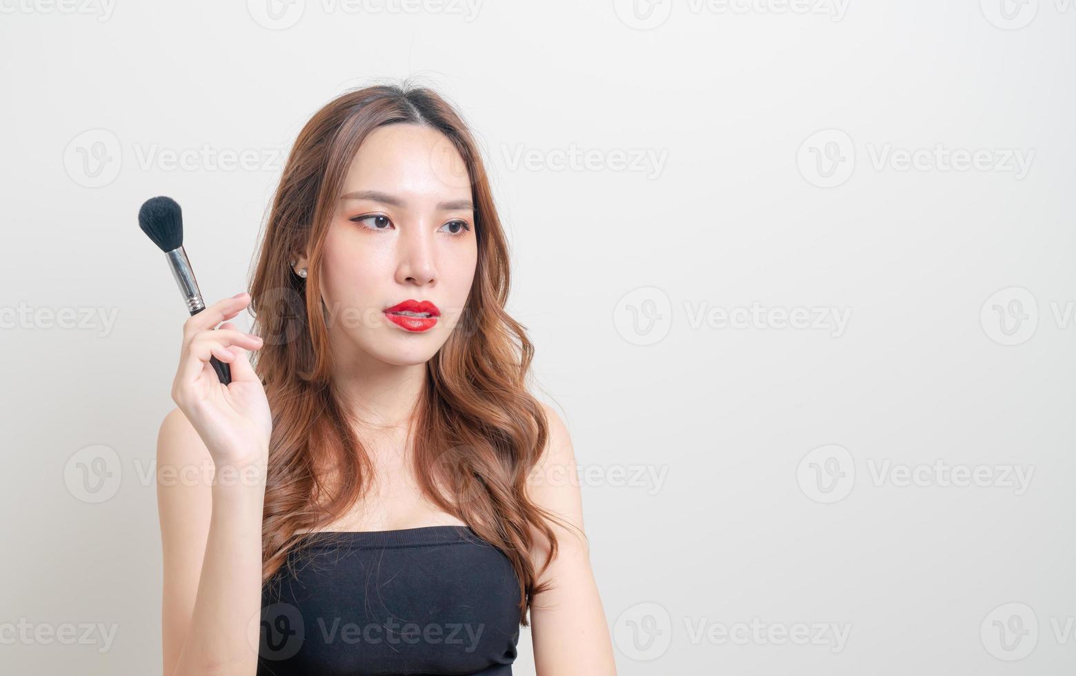 portrait beautiful woman with makeup brush photo