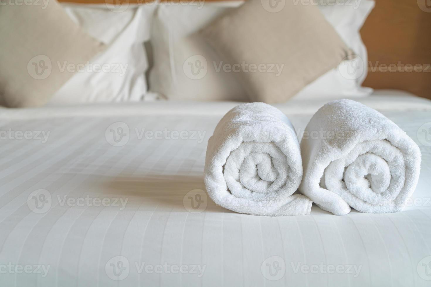 white towel on bed in bedroom photo
