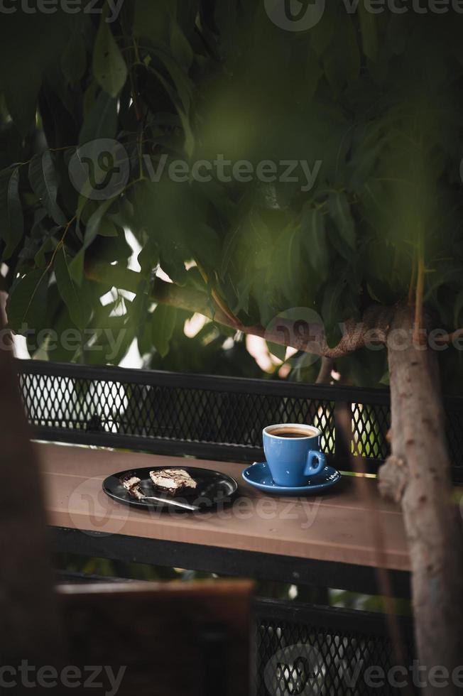 Brownie and hot coffee on wood bar photo