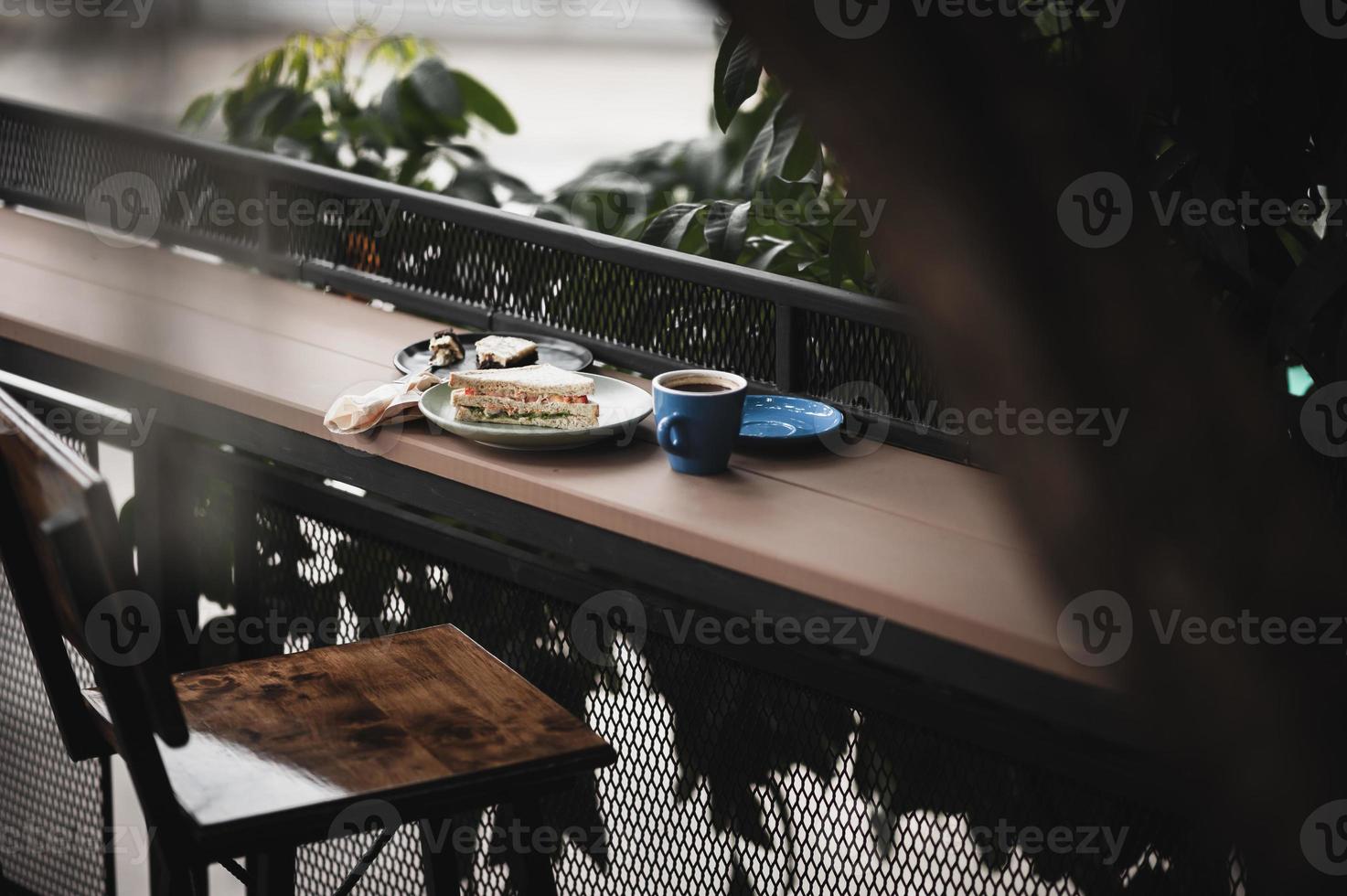 Sandwich and hot coffee on wood bar photo