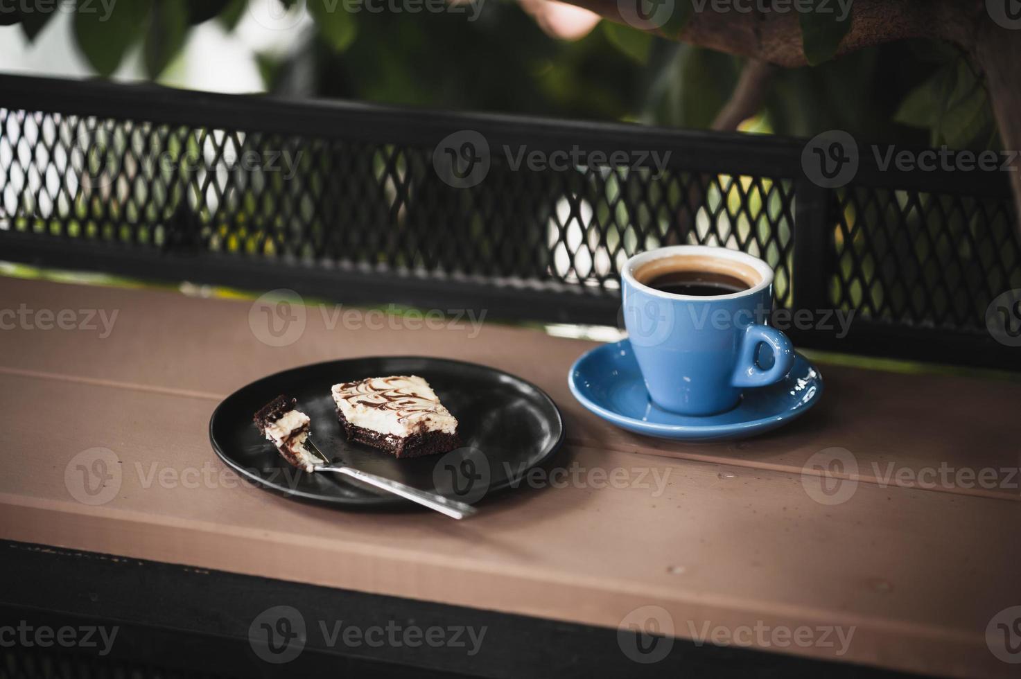 Brownie and hot coffee on wood bar photo