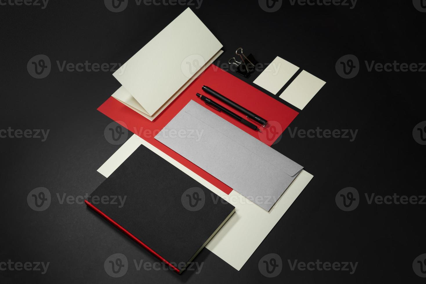 Stationery branding mockup template with red A4 Letterhead, business card, envelope, note bookpencil. photo