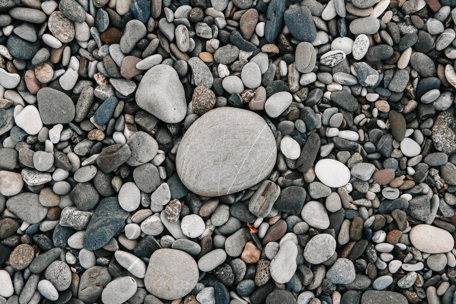 Gravel pattern of colored stones. Abstract nature pebbles background. Stone background. Sea peblles beach. Top view. photo