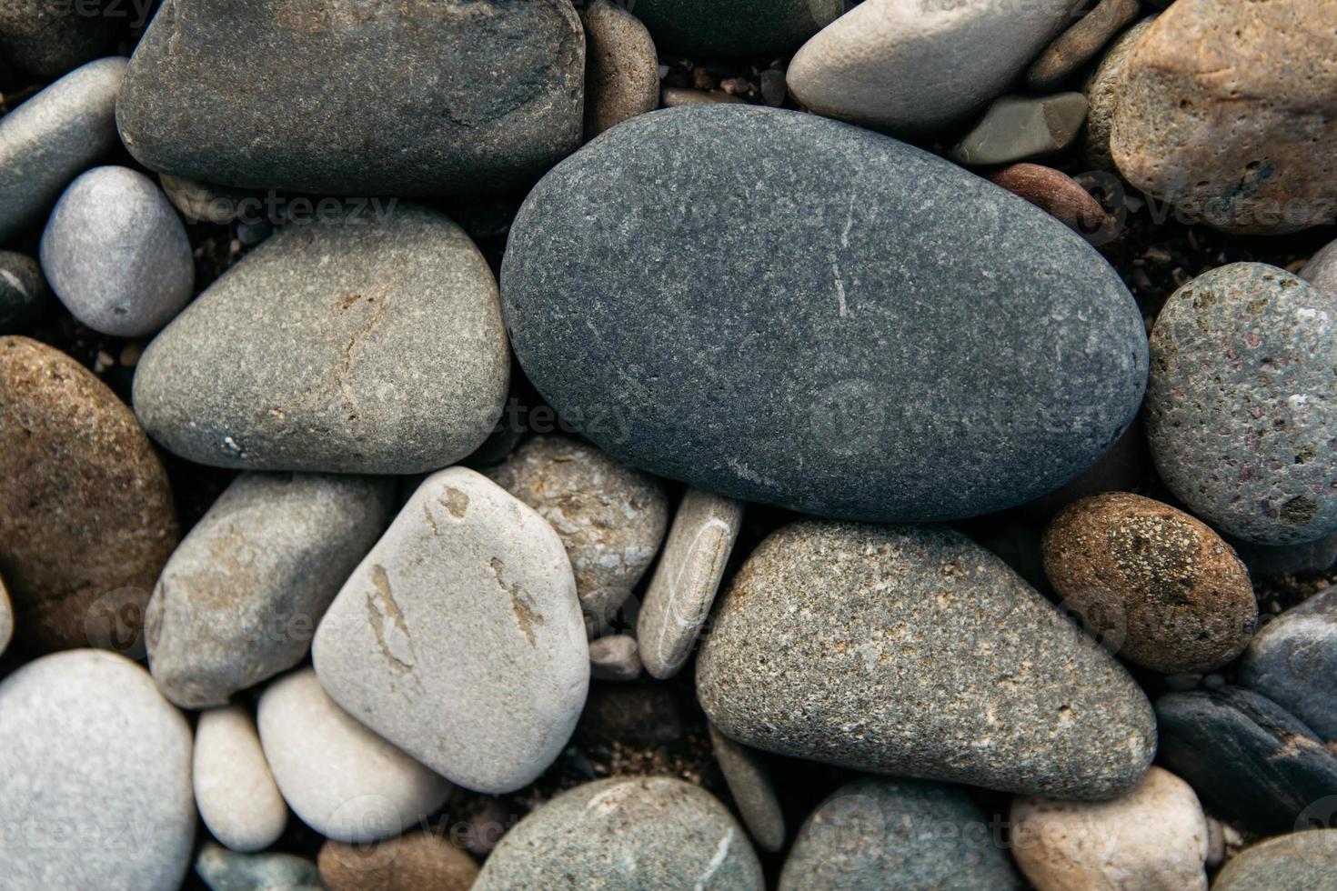 Gravel pattern of colored stones. Abstract nature pebbles background. Stone background. Sea peblles beach. Top view. photo