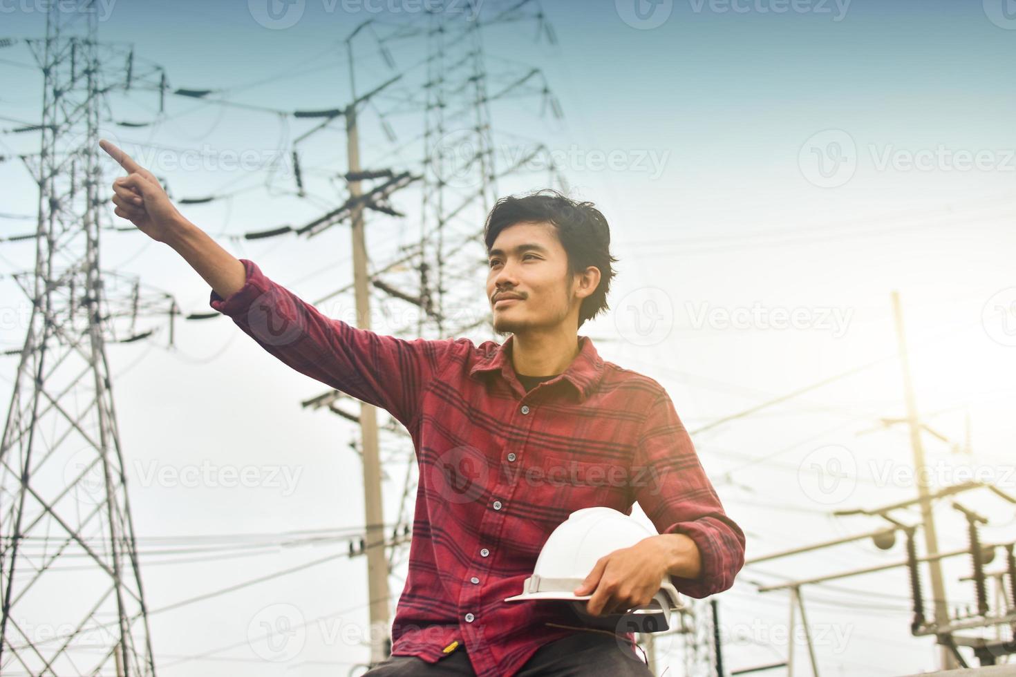 Technician holding white hat safety hard hat sunlight background photo