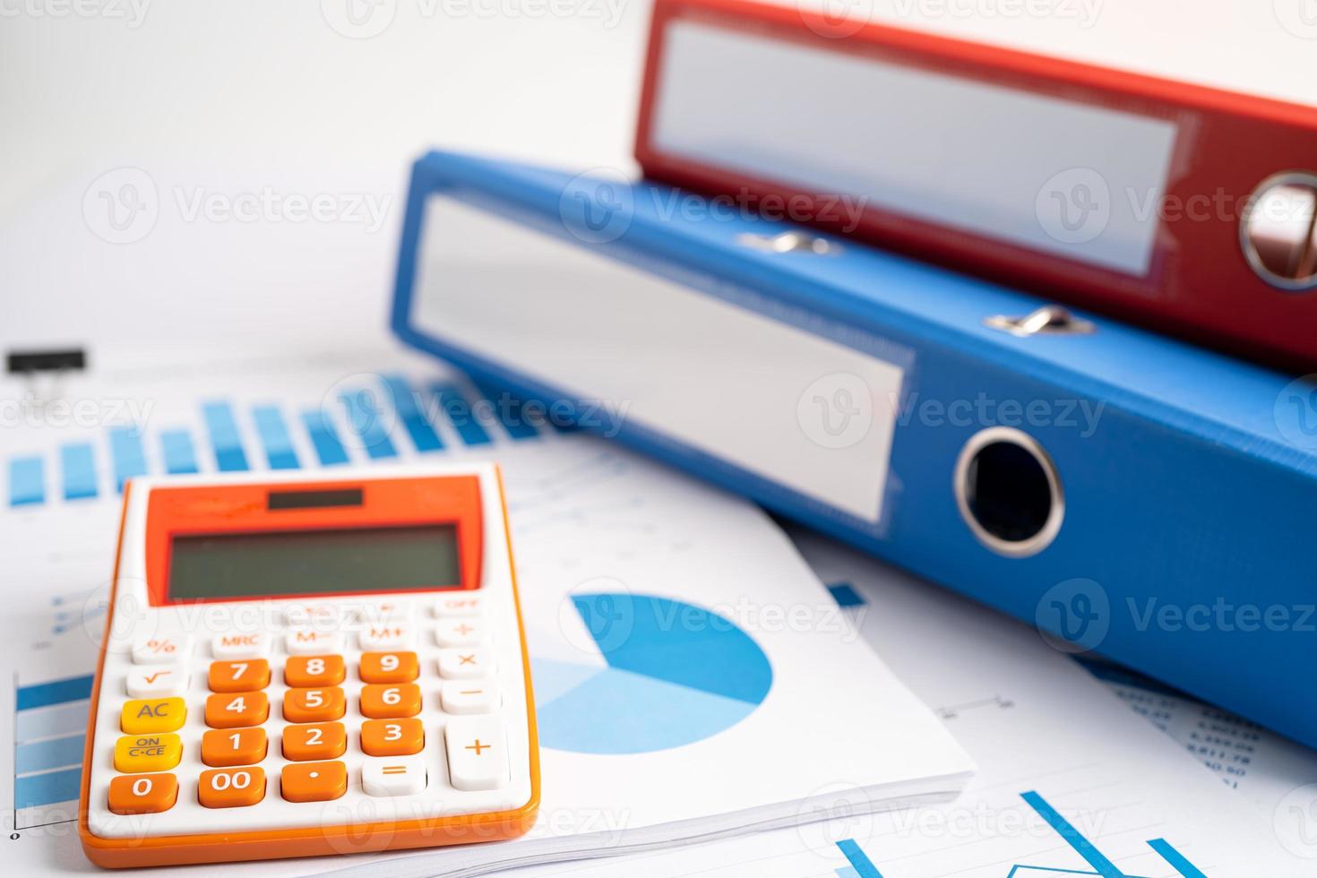 Binder data finance report business with calculator on graph analysis in office. photo