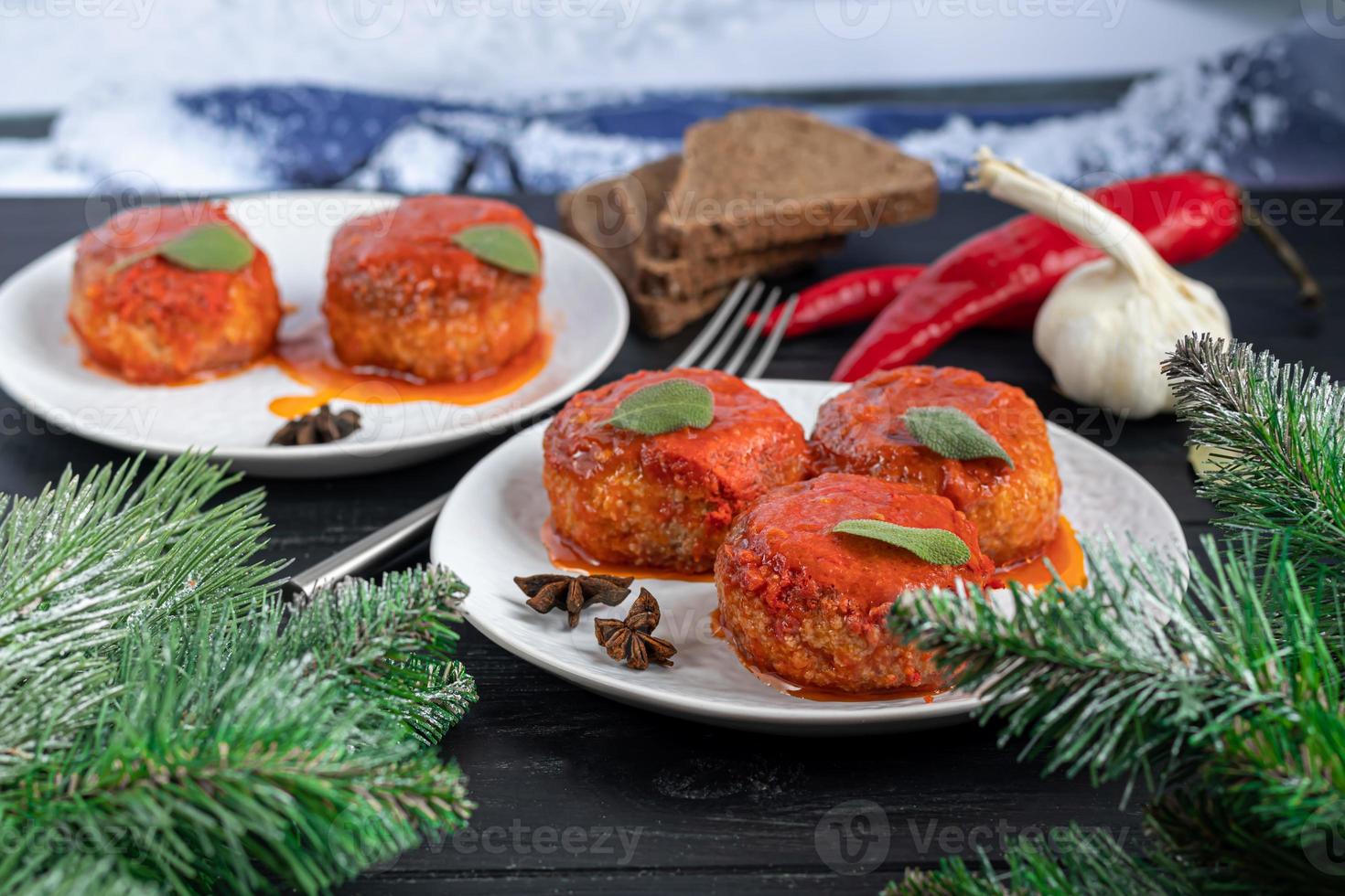 Fish cakes in tomato juice with onions and carrots. Diet. Sauerkraut. On a dark wooden background. photo