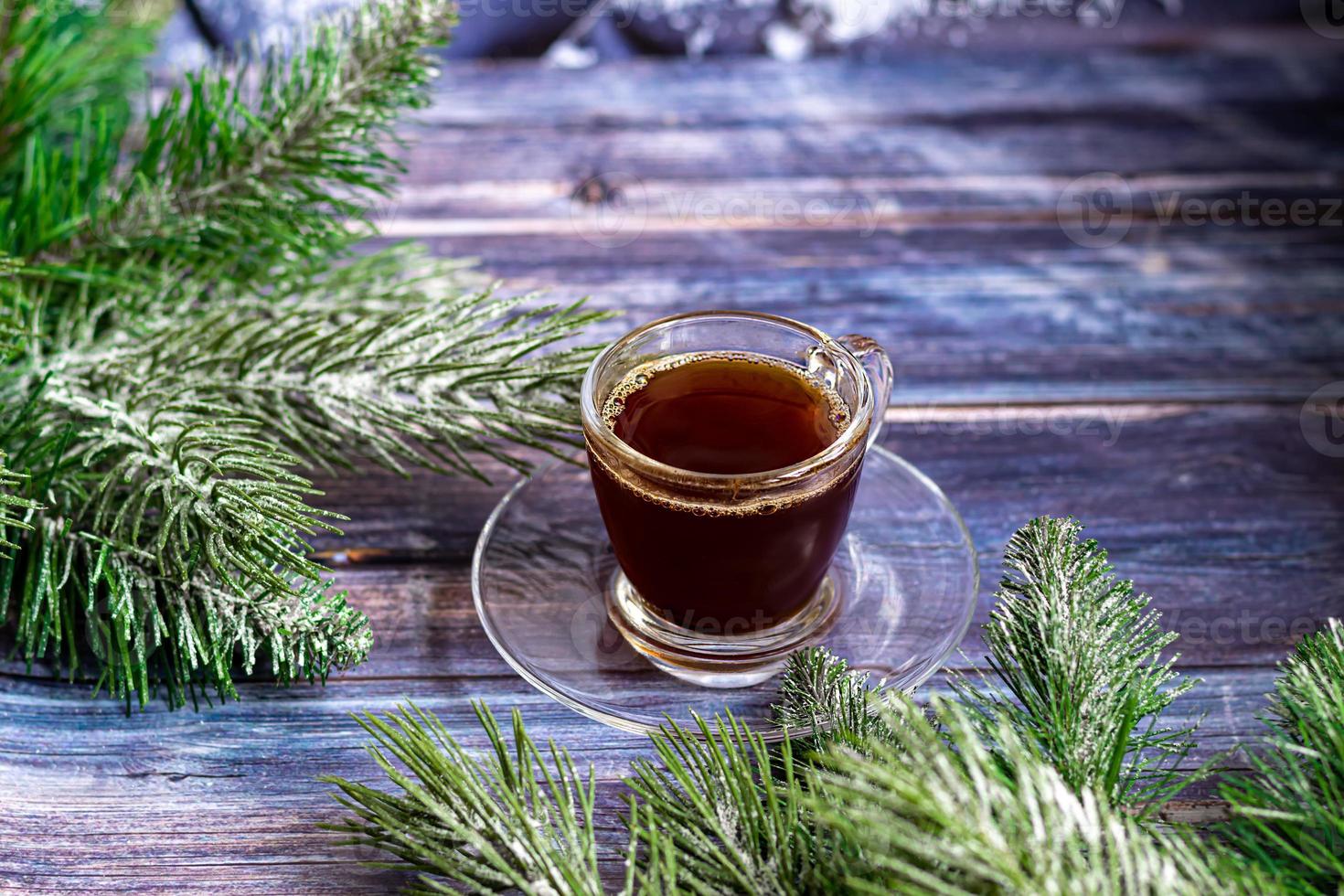 A cup of aromatic coffee with brown sugar, Christmas decorations, branches of a Christmas tree. Holiday concept New Year. On a wooden background. photo