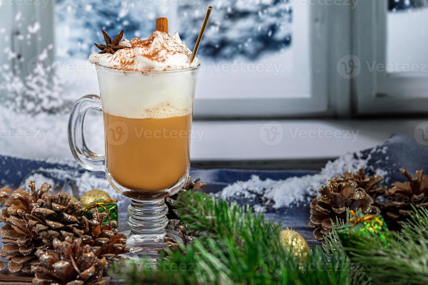 Hot coffee latte with cinnamon sticks, sprinkled with cinnamon. Christmas decorations, branches of a Christmas tree. Holiday concept New Year. photo