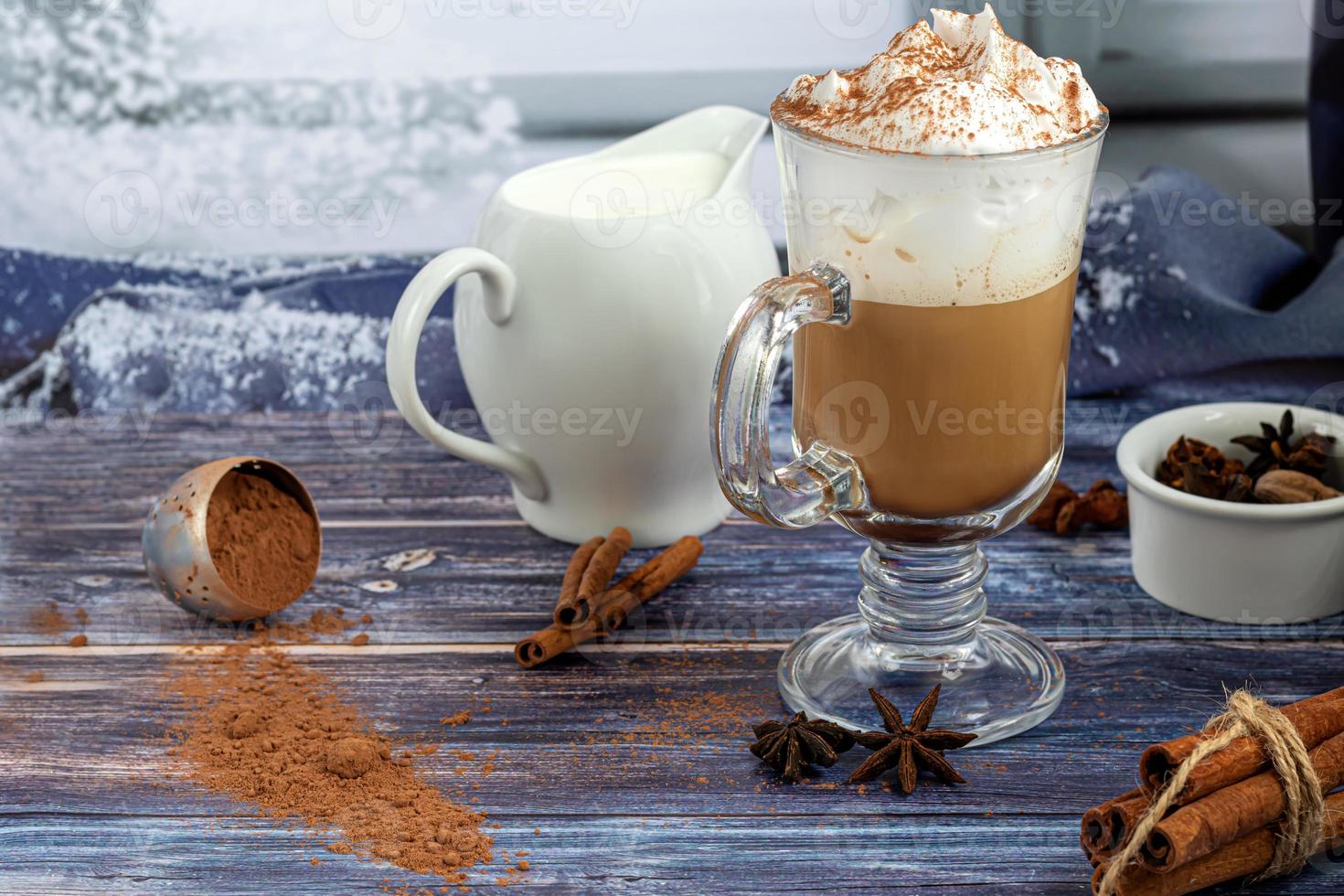 Hot coffee latte with cinnamon sticks, sprinkled with cinnamon. Christmas decorations, branches of a Christmas tree. Holiday concept New Year. photo