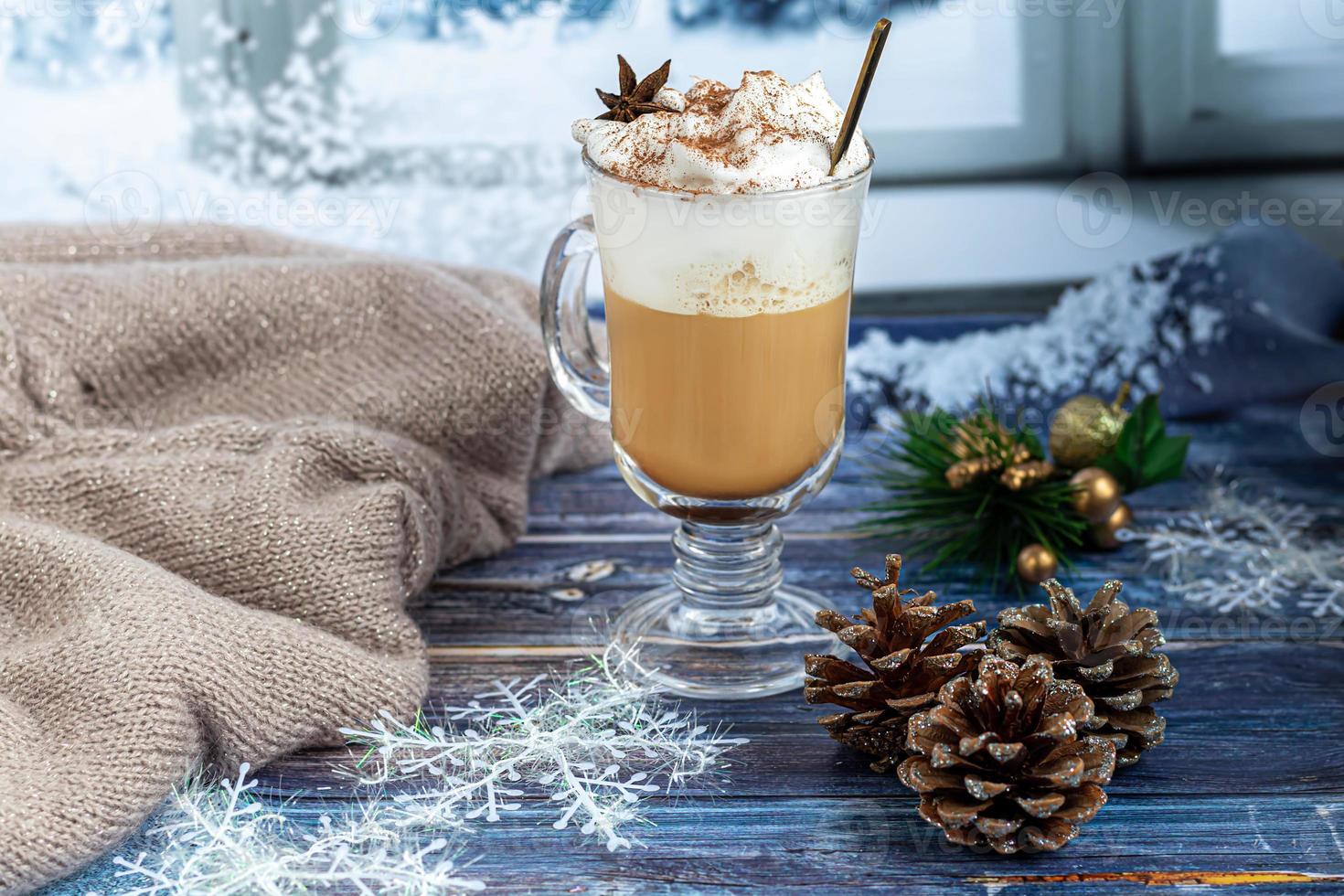 Hot coffee latte with cinnamon sticks, sprinkled with cinnamon. Christmas decorations, branches of a Christmas tree. Holiday concept New Year. photo