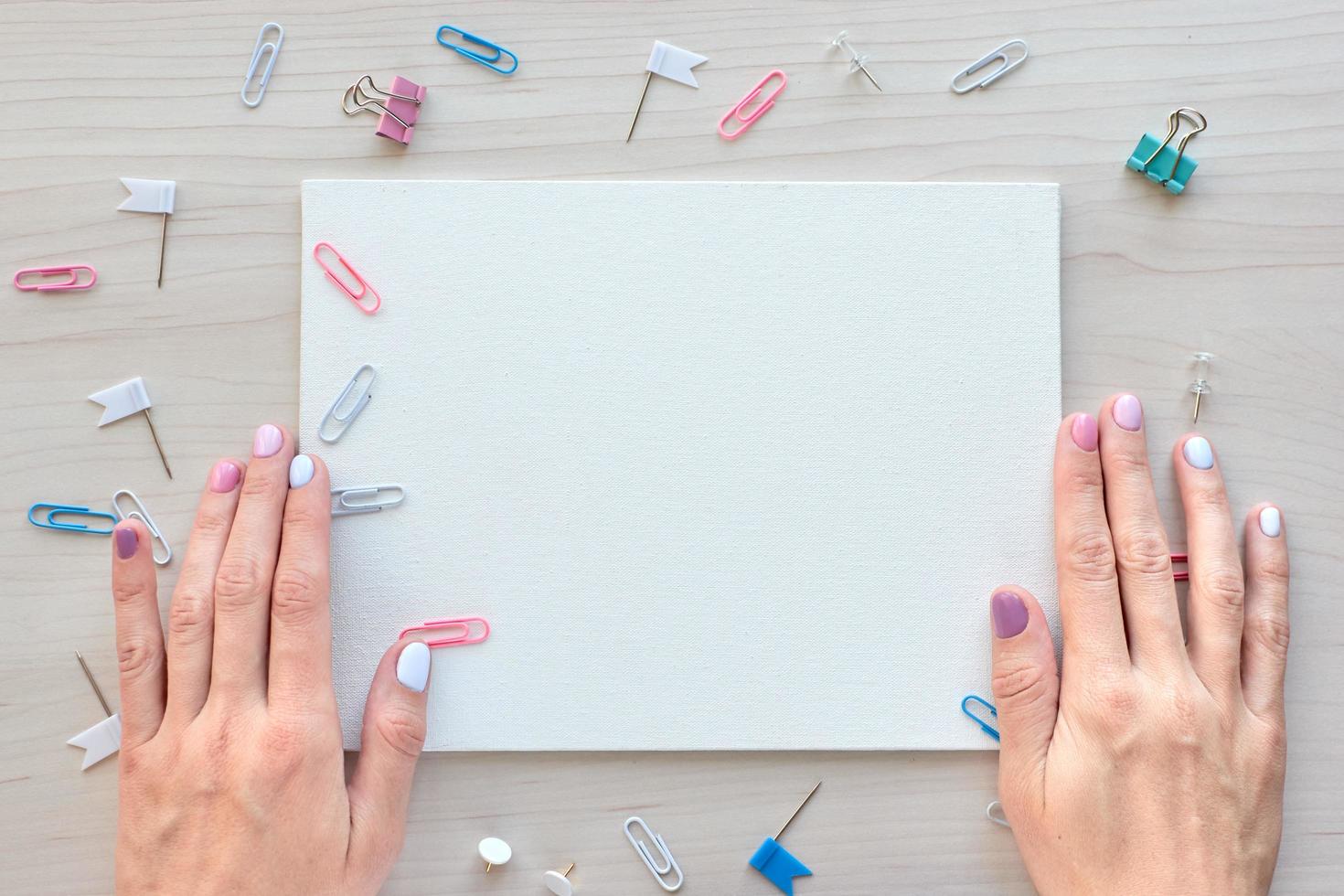 School office supplies on wooden background. Back to school concept. White board with hands for copy space. Top view ready for your design photo