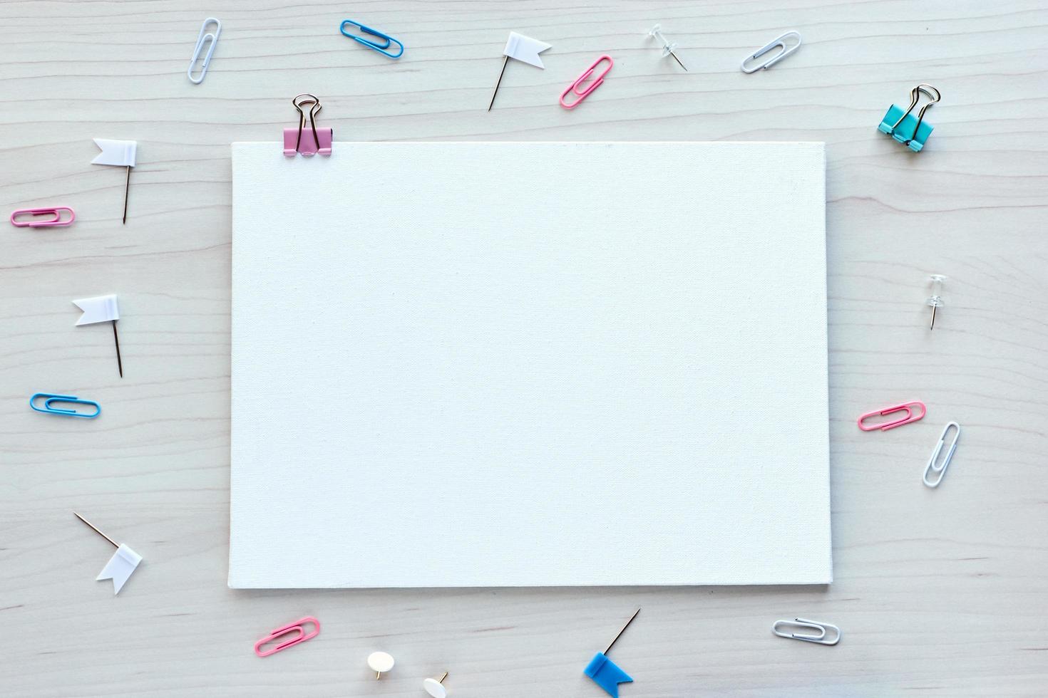 School office supplies on wooden background. Back to school concept. White board with hands for copy space. Top view ready for your design photo