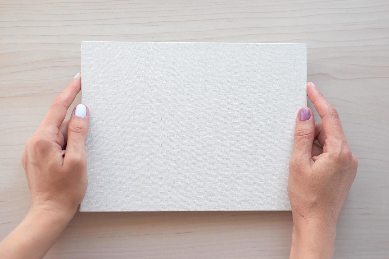 White board with hands for copy space. School office supplies on wooden background. Back to school concept. Top view ready for your design photo