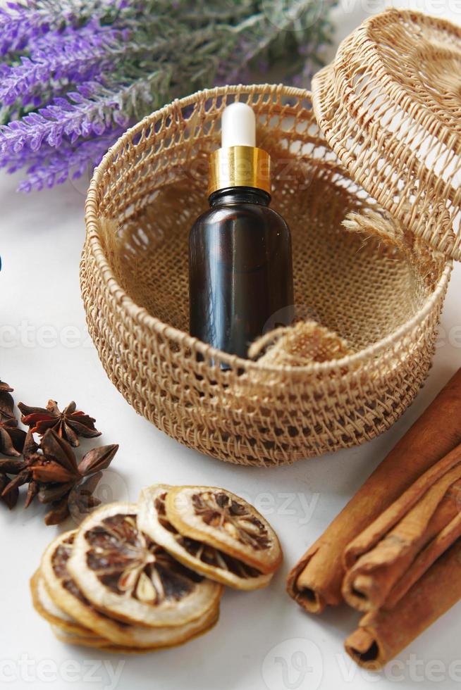 essential citrus oil, dried lemon and spice on table , photo