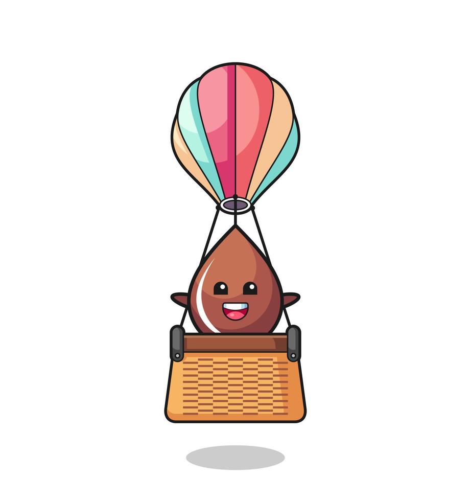 mascota gota de chocolate montando un globo aerostático vector