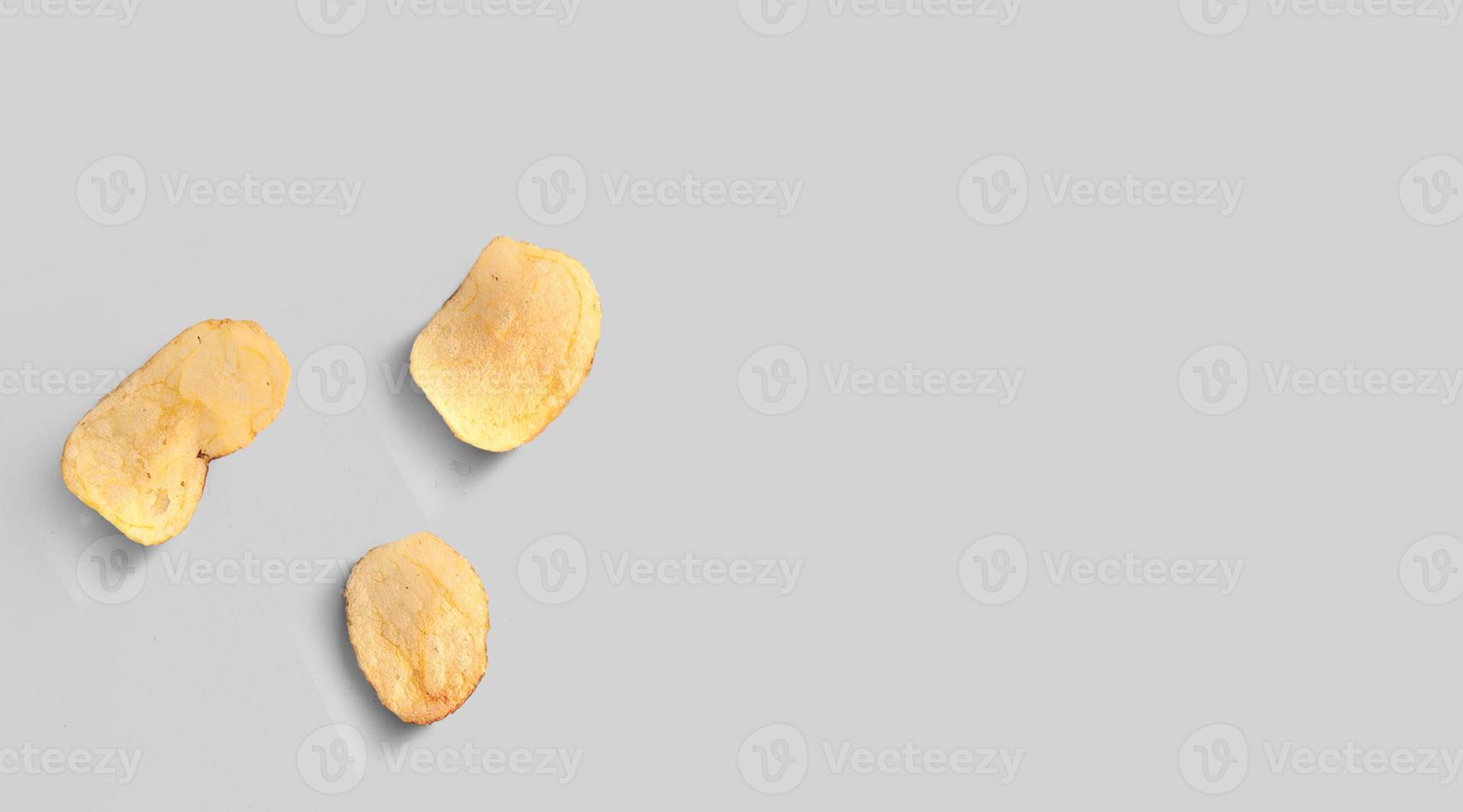 Potato chips isolated on grey background close-up. Top view. Flat lay photo