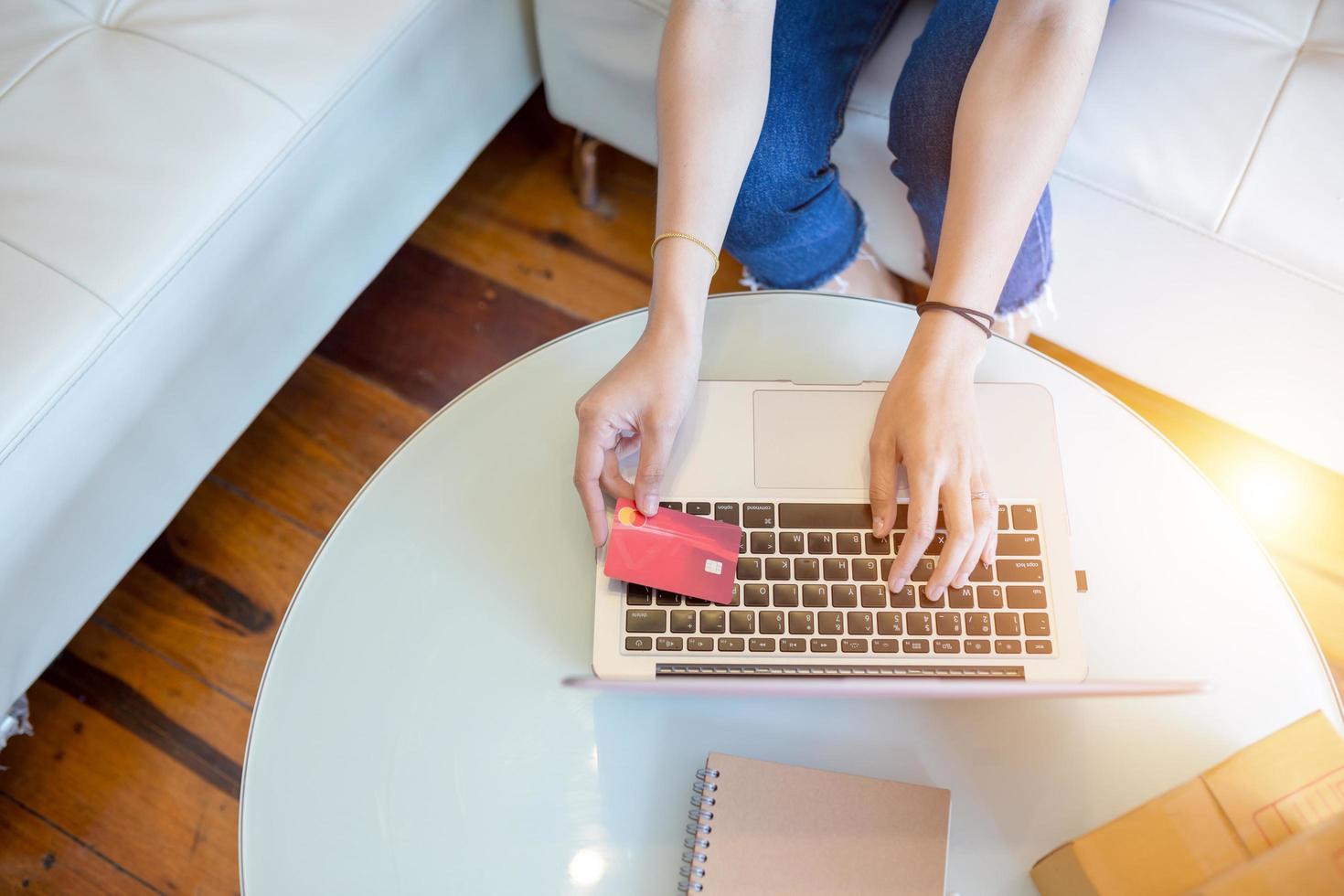 Young women shopping online using laptop and pay with credit card. Close up hands holding credit card this technology marketplace online. photo