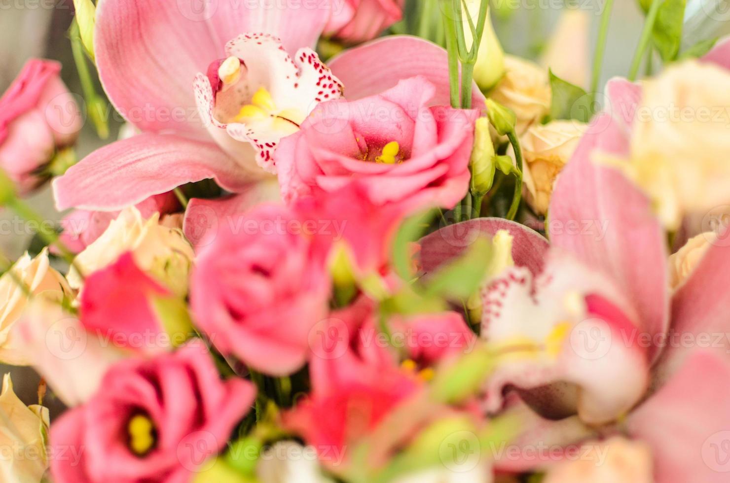Bouquet with orchids and roses on a beautiful background photo