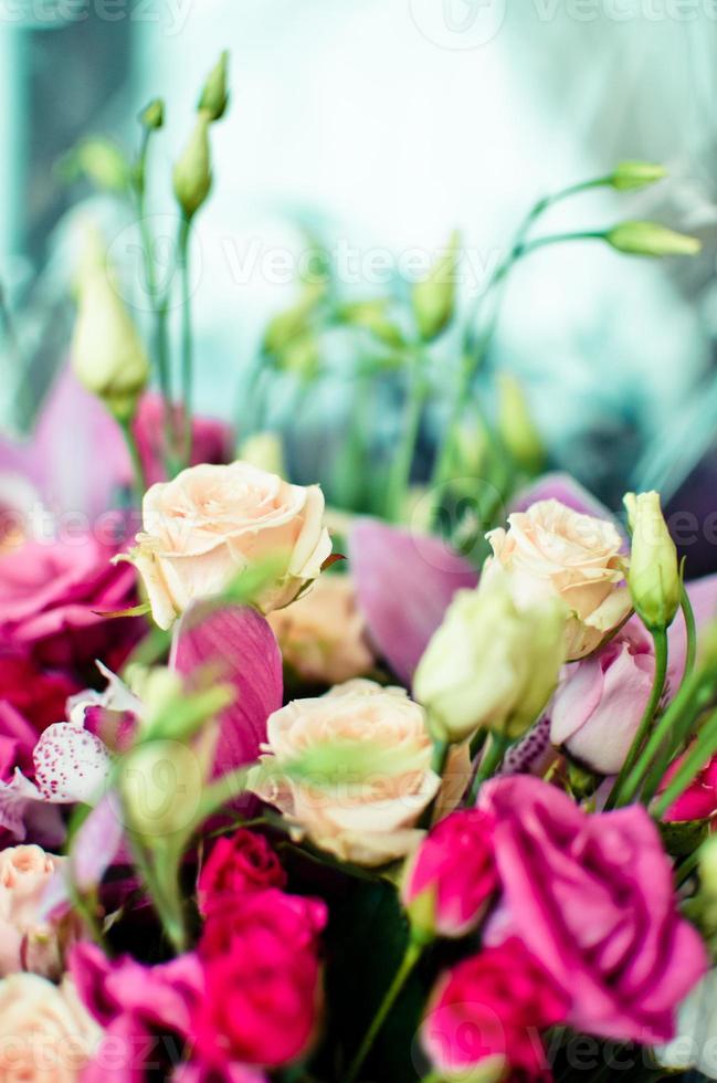 Bouquet with orchids and roses on a beautiful background photo