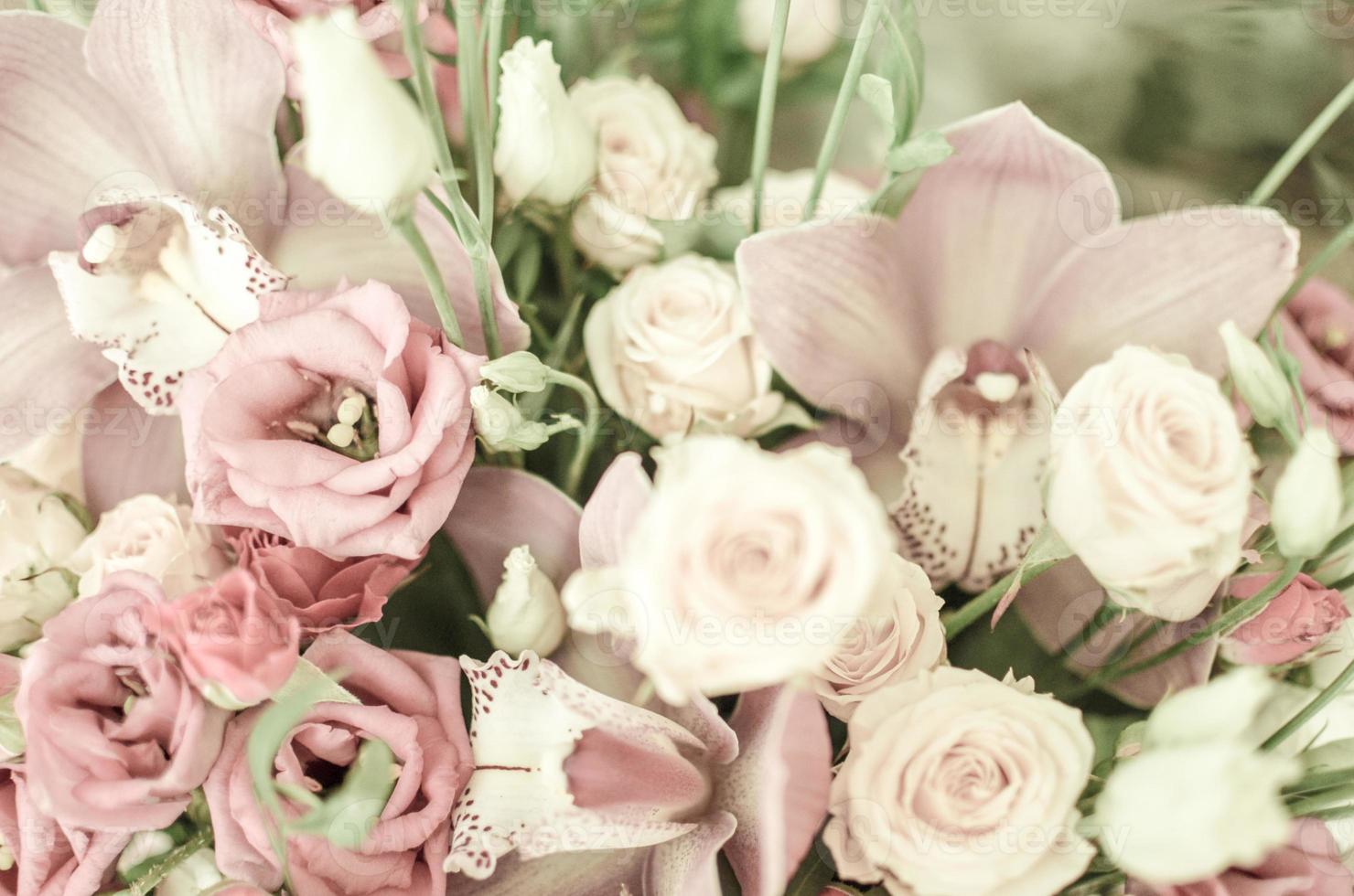 Bouquet with orchids and roses on a beautiful background photo