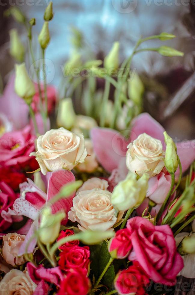 Bouquet with orchids and roses on a beautiful background photo