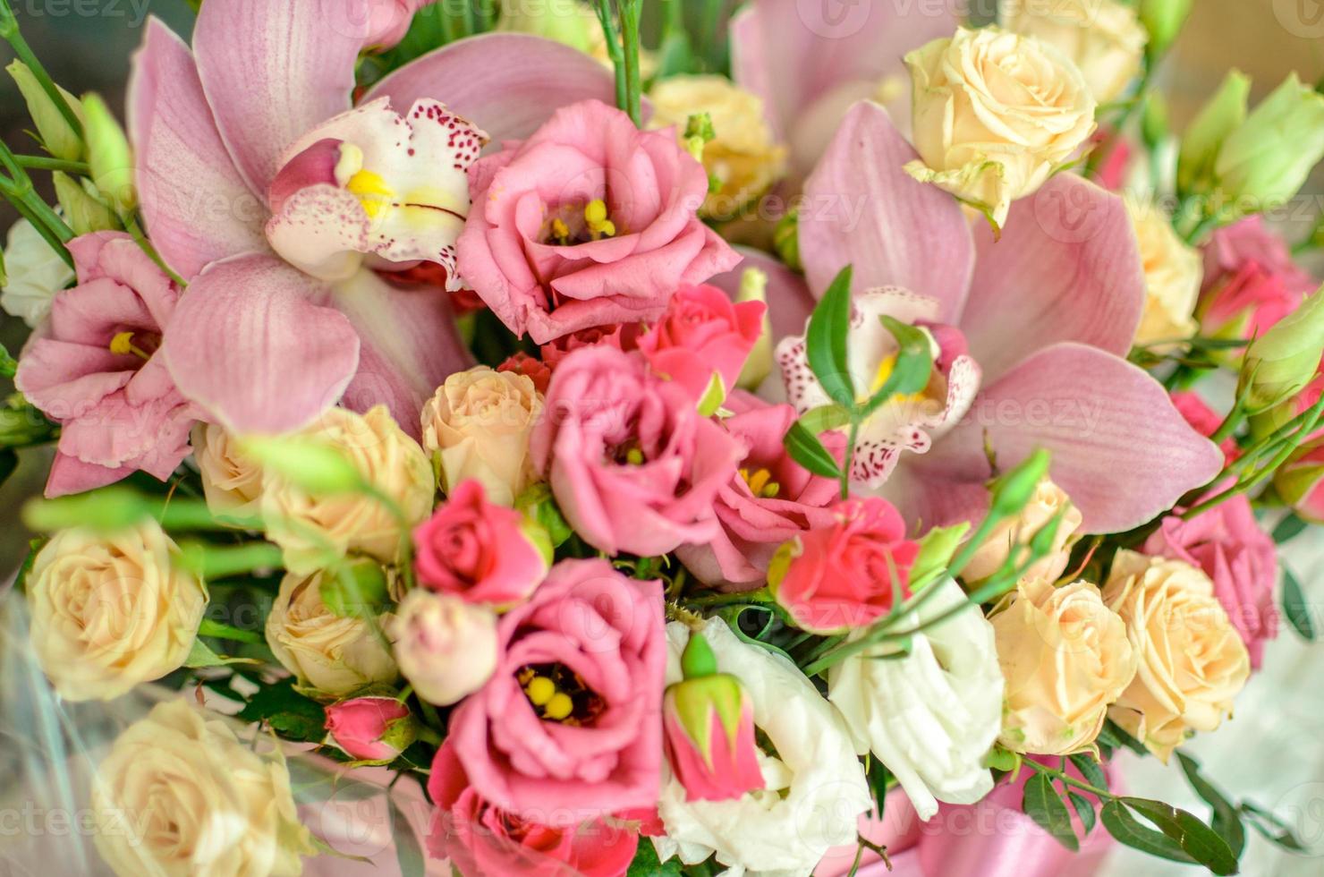 Bouquet with orchids and roses on a beautiful background photo