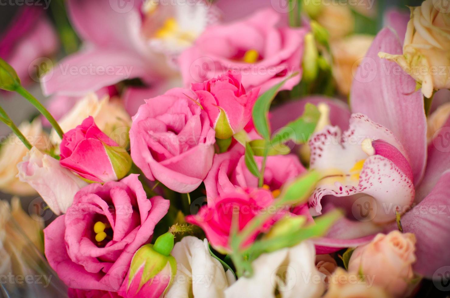 Bouquet with orchids and roses on a beautiful background photo