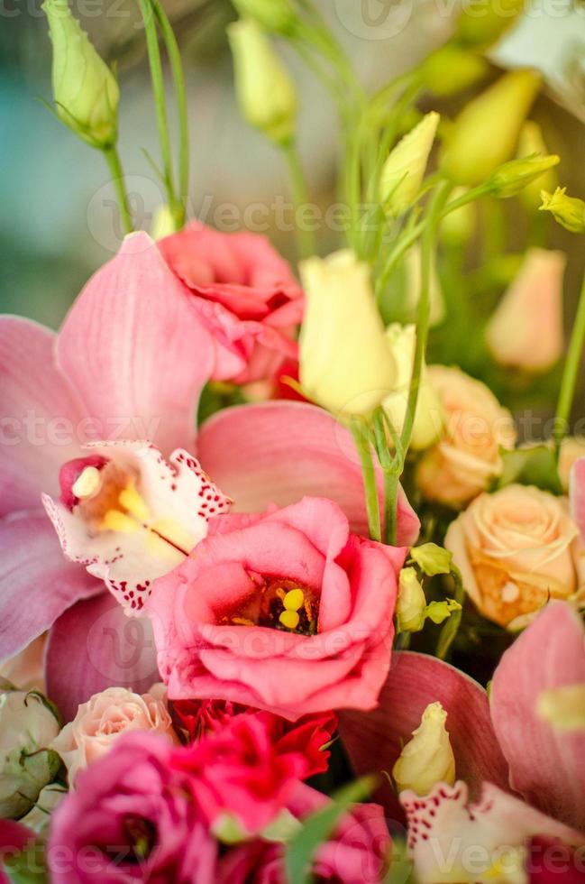 Bouquet with orchids and roses on a beautiful background photo