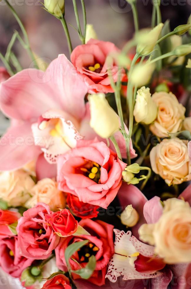 Bouquet with orchids and roses on a beautiful background photo