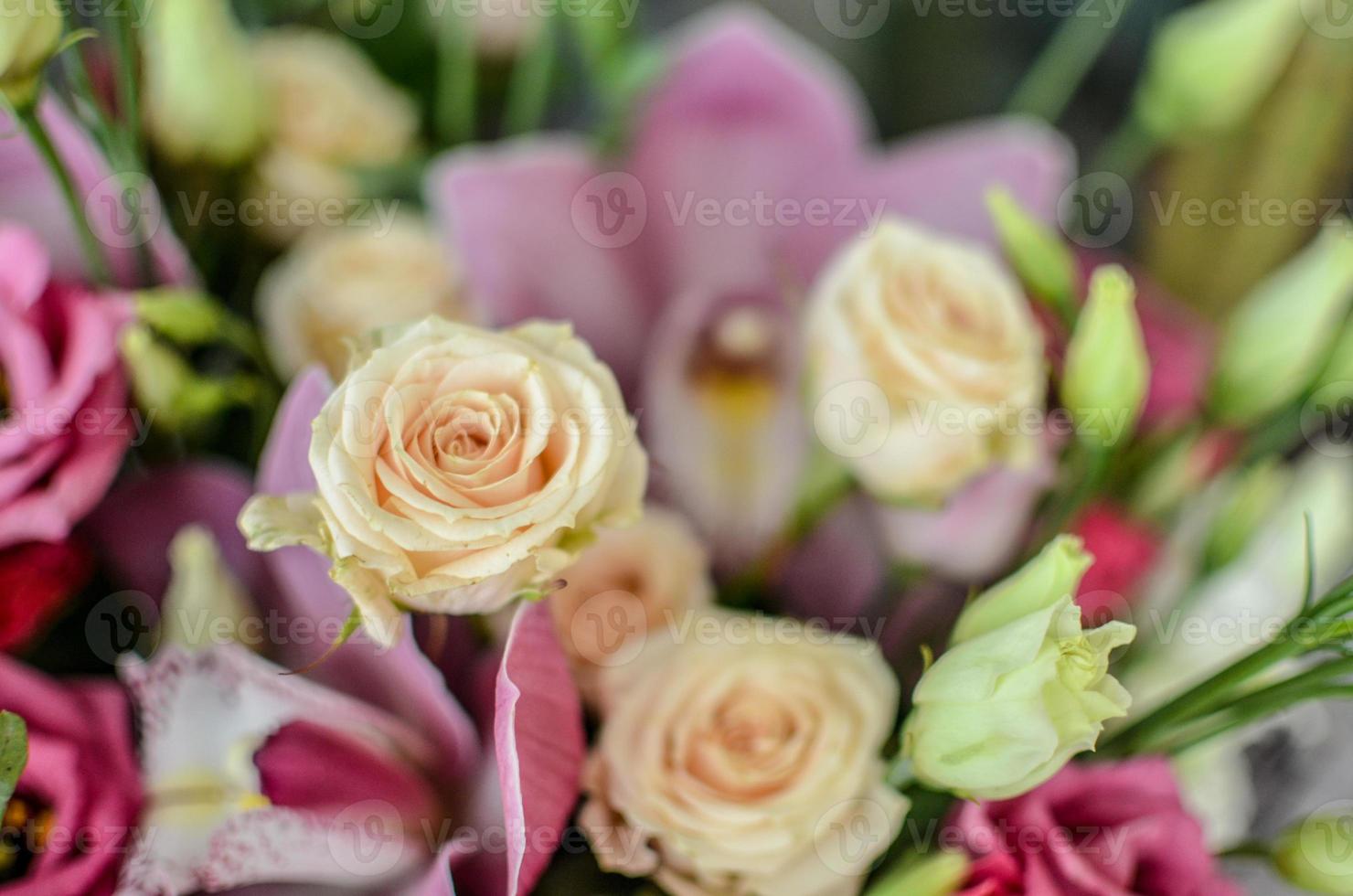Bouquet with orchids and roses on a beautiful background photo