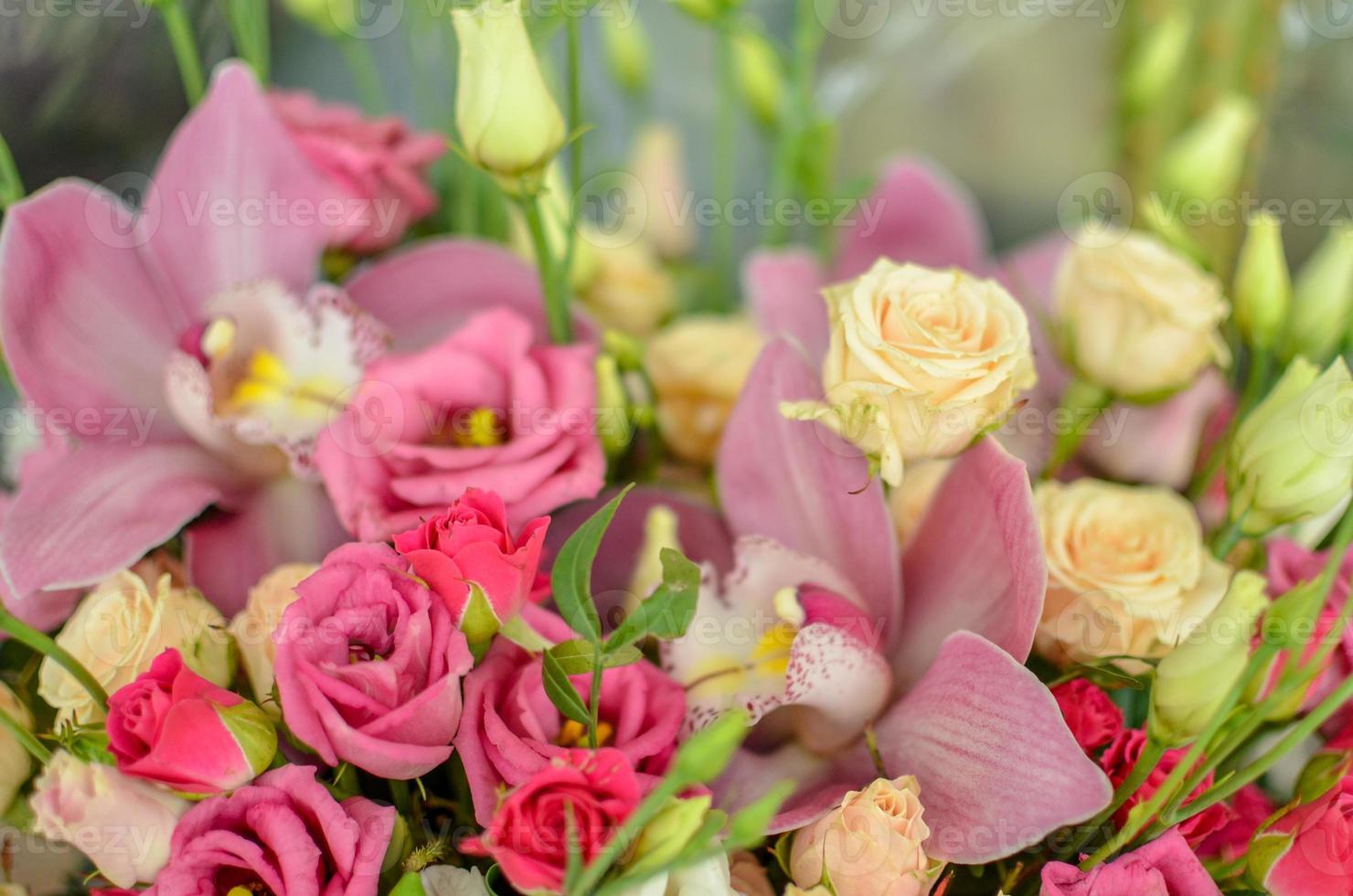 Bouquet with orchids and roses on a beautiful background photo